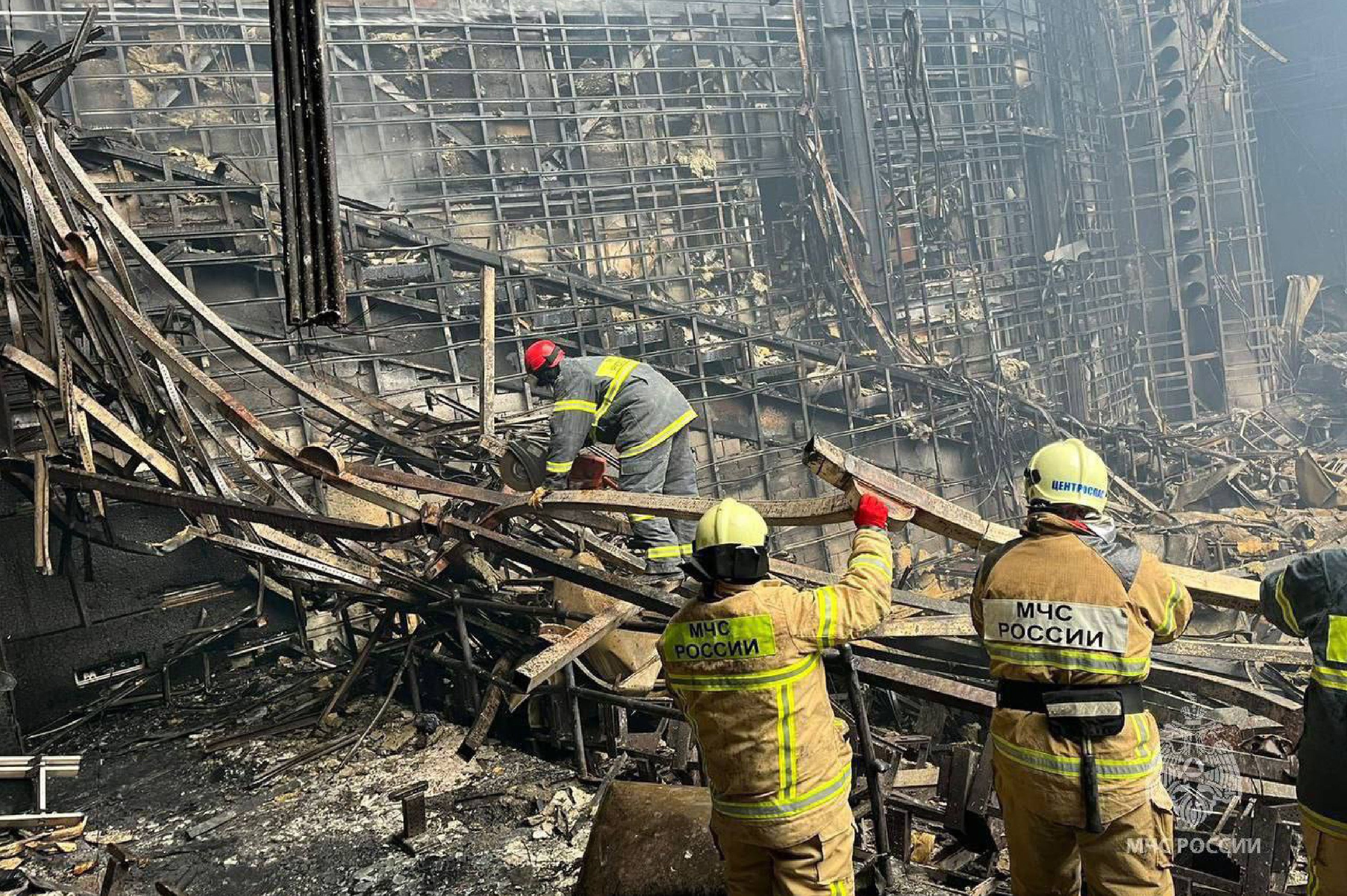 Rescuers moving the rubble after the roof of Crocus City Hall burnt down