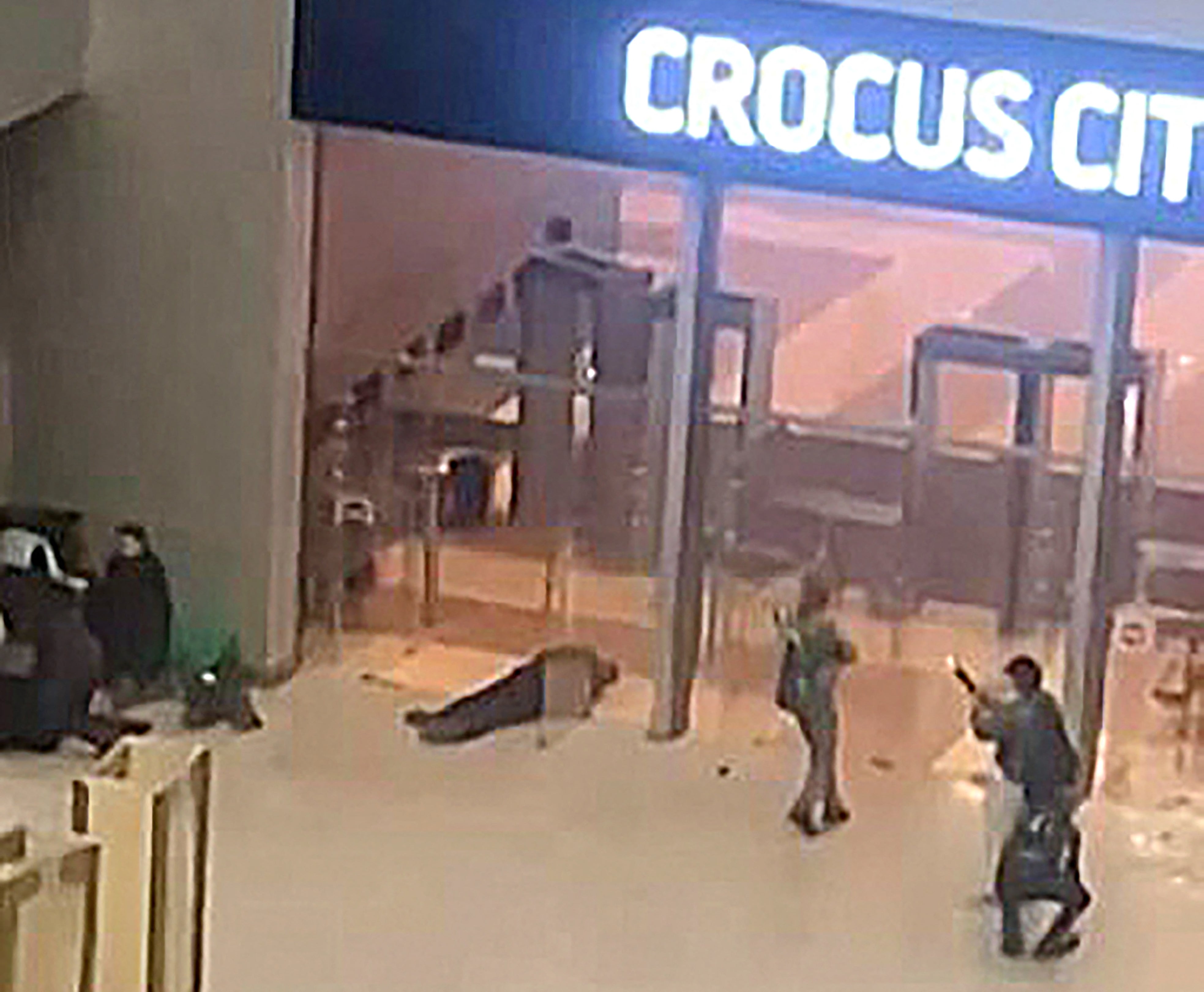 Gunmen shown moving through the foyer of the concert hall