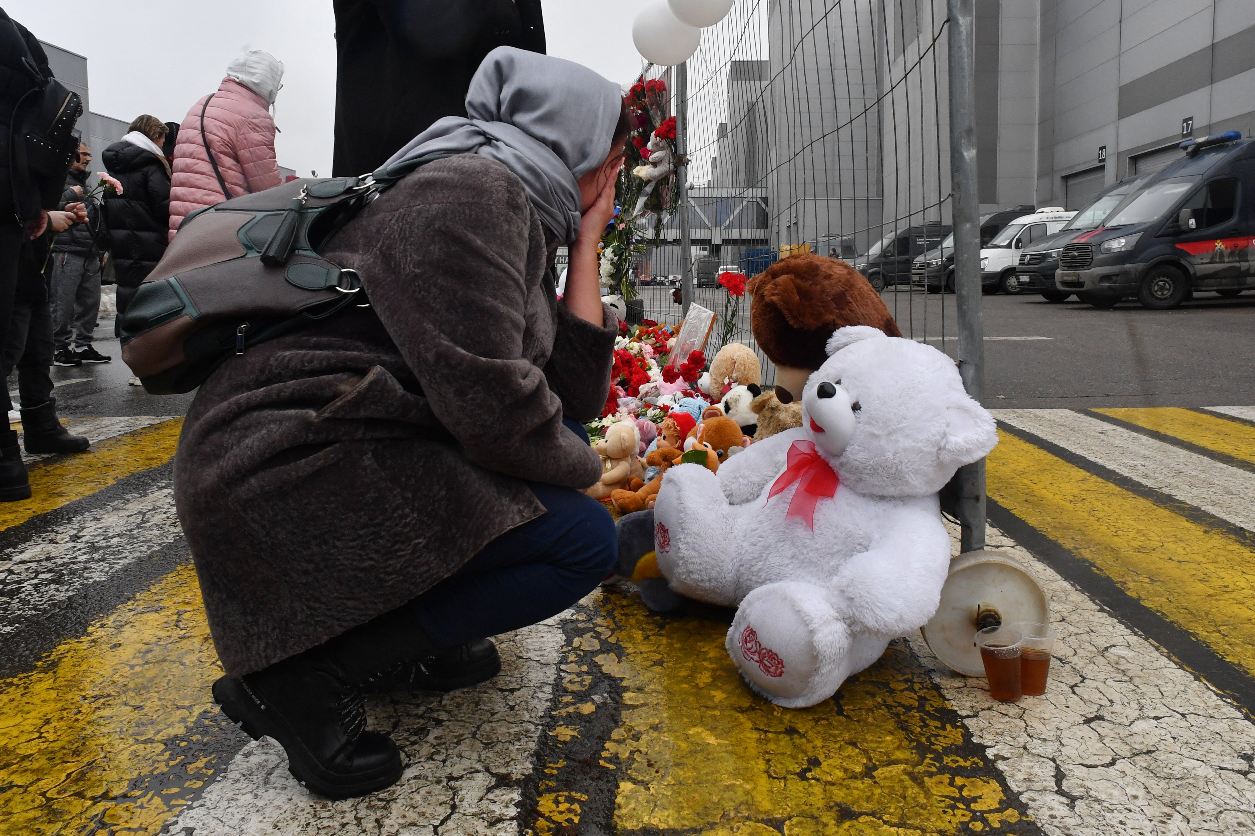 A woman mourns at a makeshift memorial in front of Crocus City Hall