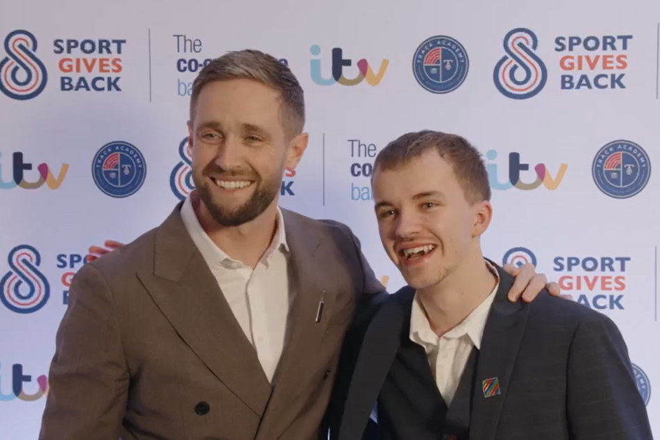 England cricketer Chris Woakes smiles with award winner Connor Hyde (ITV/PA)