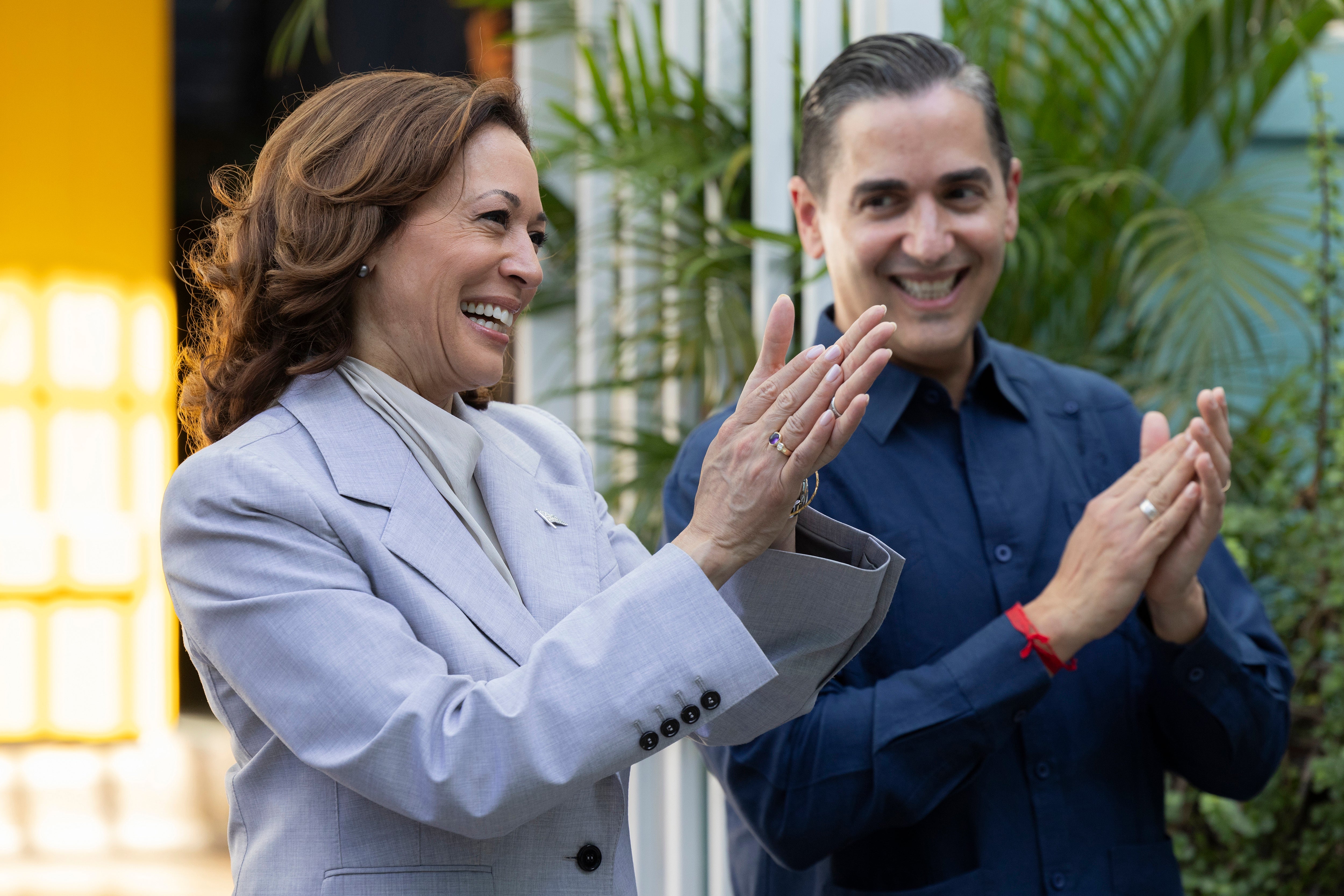 Vice President Kamala Harris, left, and Frankie Miranda, Hispanic Federation president, applaud, during a visit, in San Juan, Puerto Rico