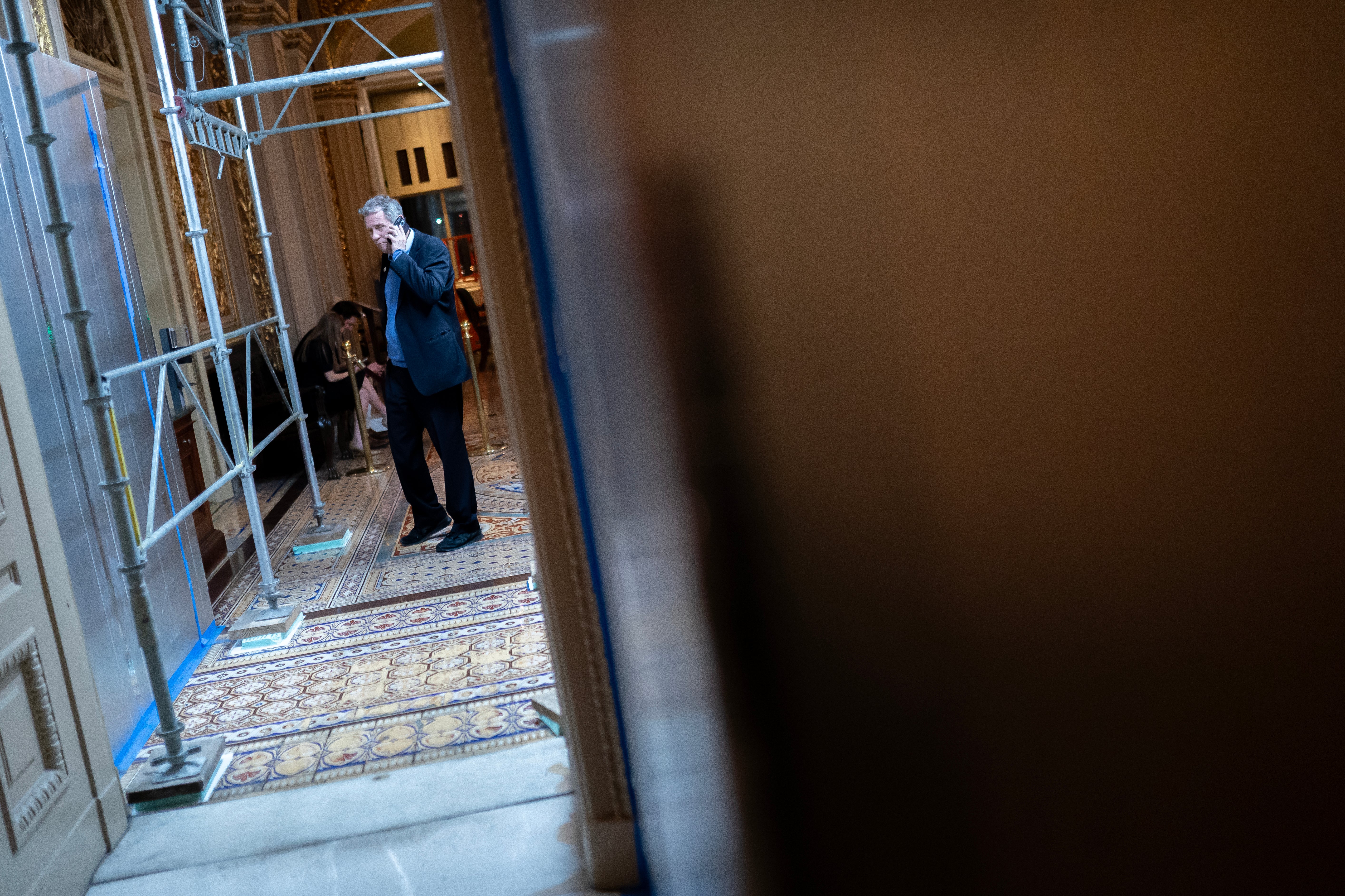 WASHINGTON, DC - MARCH 23: U.S. Sen. Sherrod Brown (D-OH) talks on the phone near the Senate Chambers on March 23, 2024 in Washington, DC. The House of Representatives passed a $1.2 trillion spending bill to fund the government through September and avert a partial shutdown. The legislation will now go to the Senate for consideration. (Photo by Nathan Howard/Getty Images)