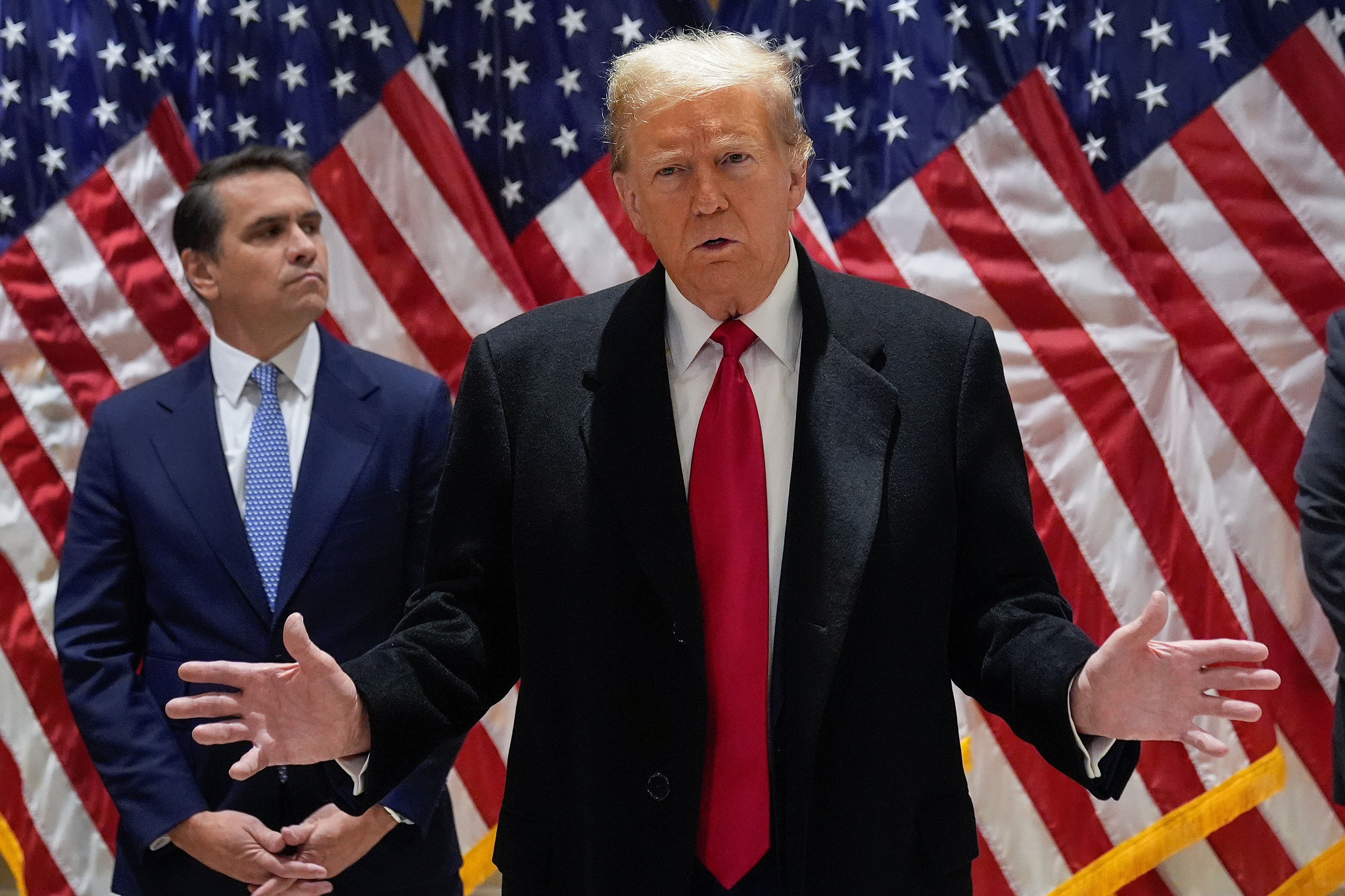 Donald Trump speaks to reporters from 40 Wall Street on 25 March.