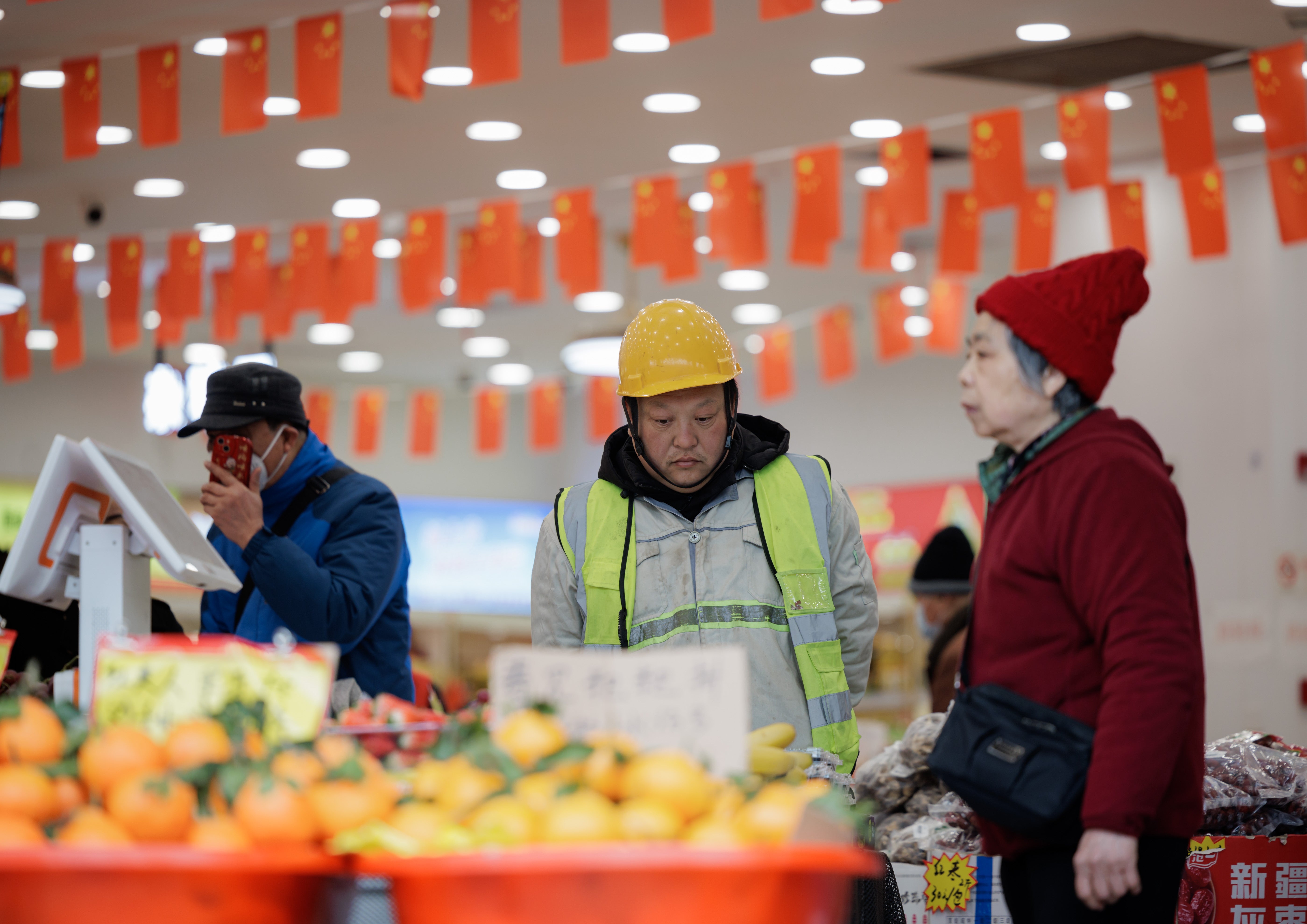 People stand in a grocery store in Shanghai, China