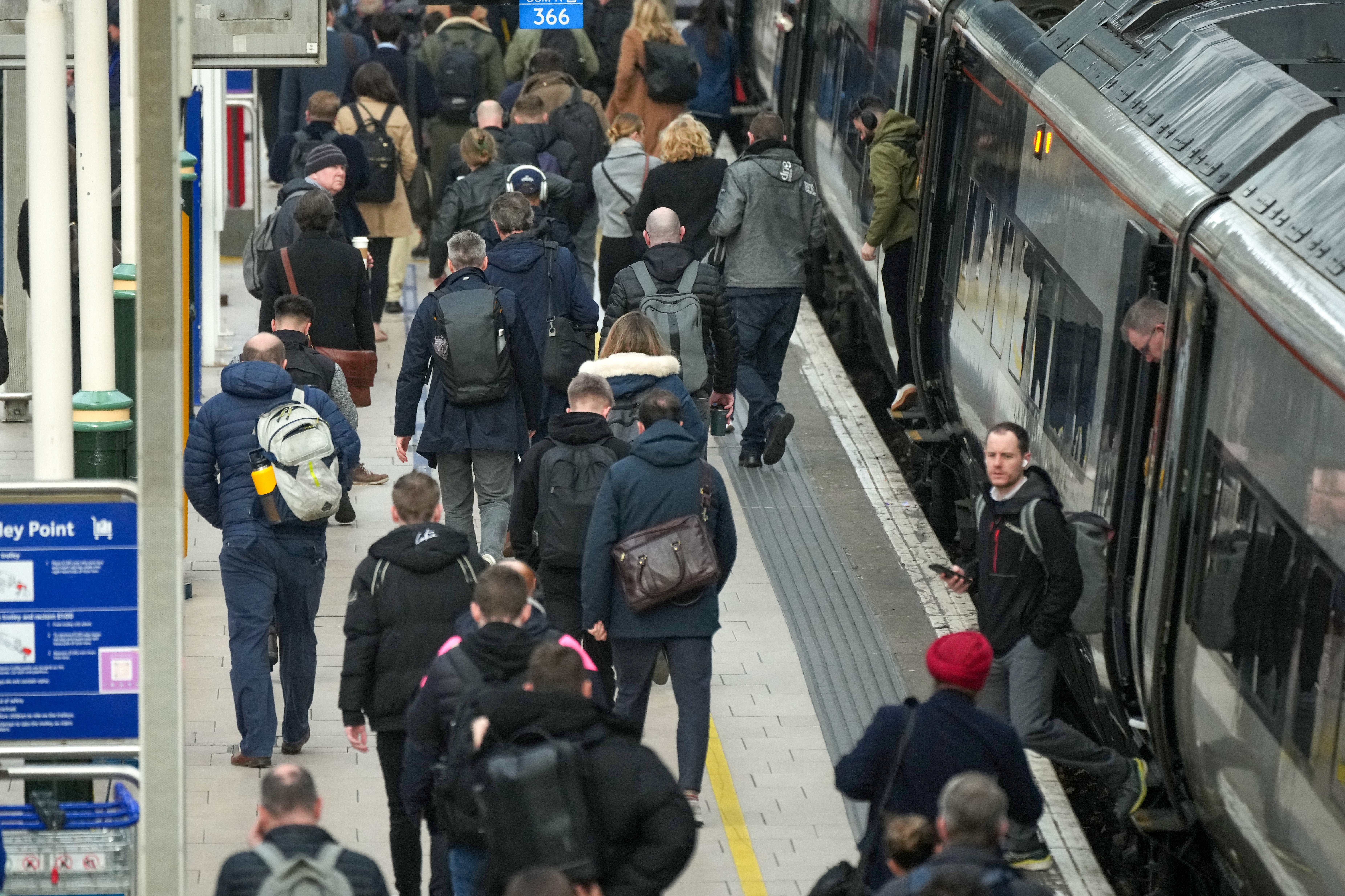 Commuters make their way to work in Manchester City centre