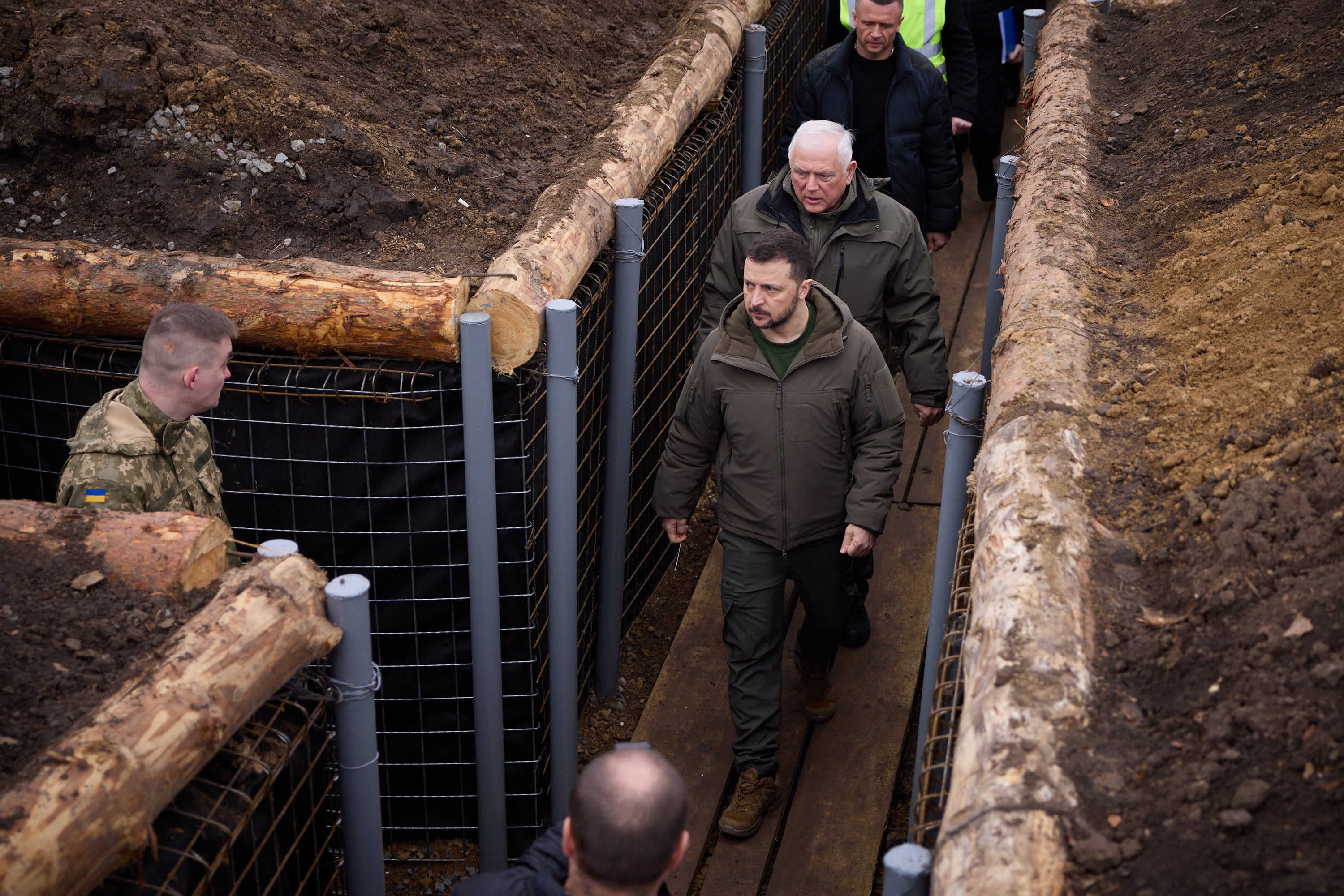 Ukraine's President Volodymyr Zelensky walking along trenches on the location of the 117th separate brigade of territorial defence in the Sumy region, amid the Russian invasion of Ukraine