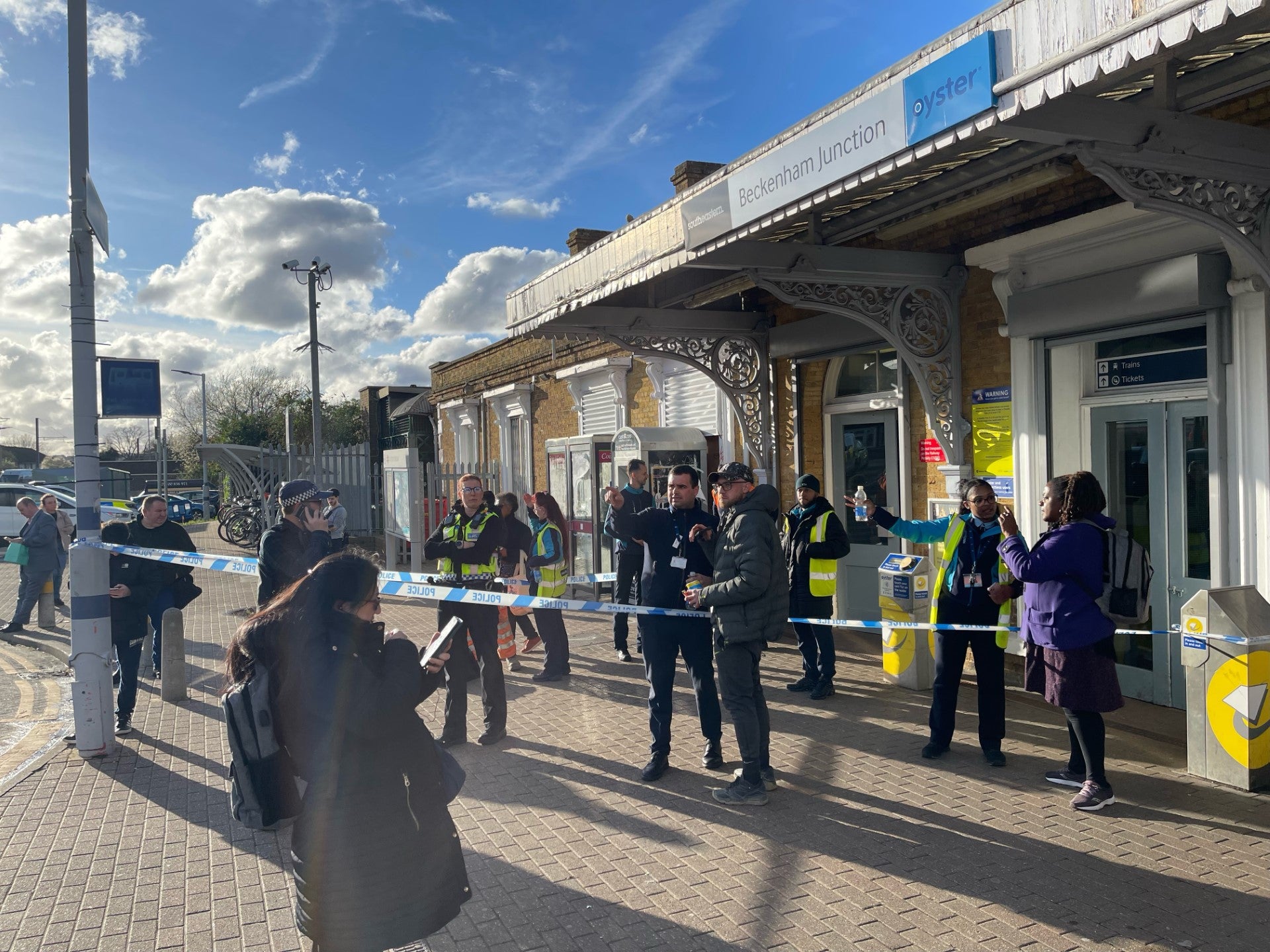 Police can be seen stood outside Beckenham Junction, which was taped off as police investigated the incident