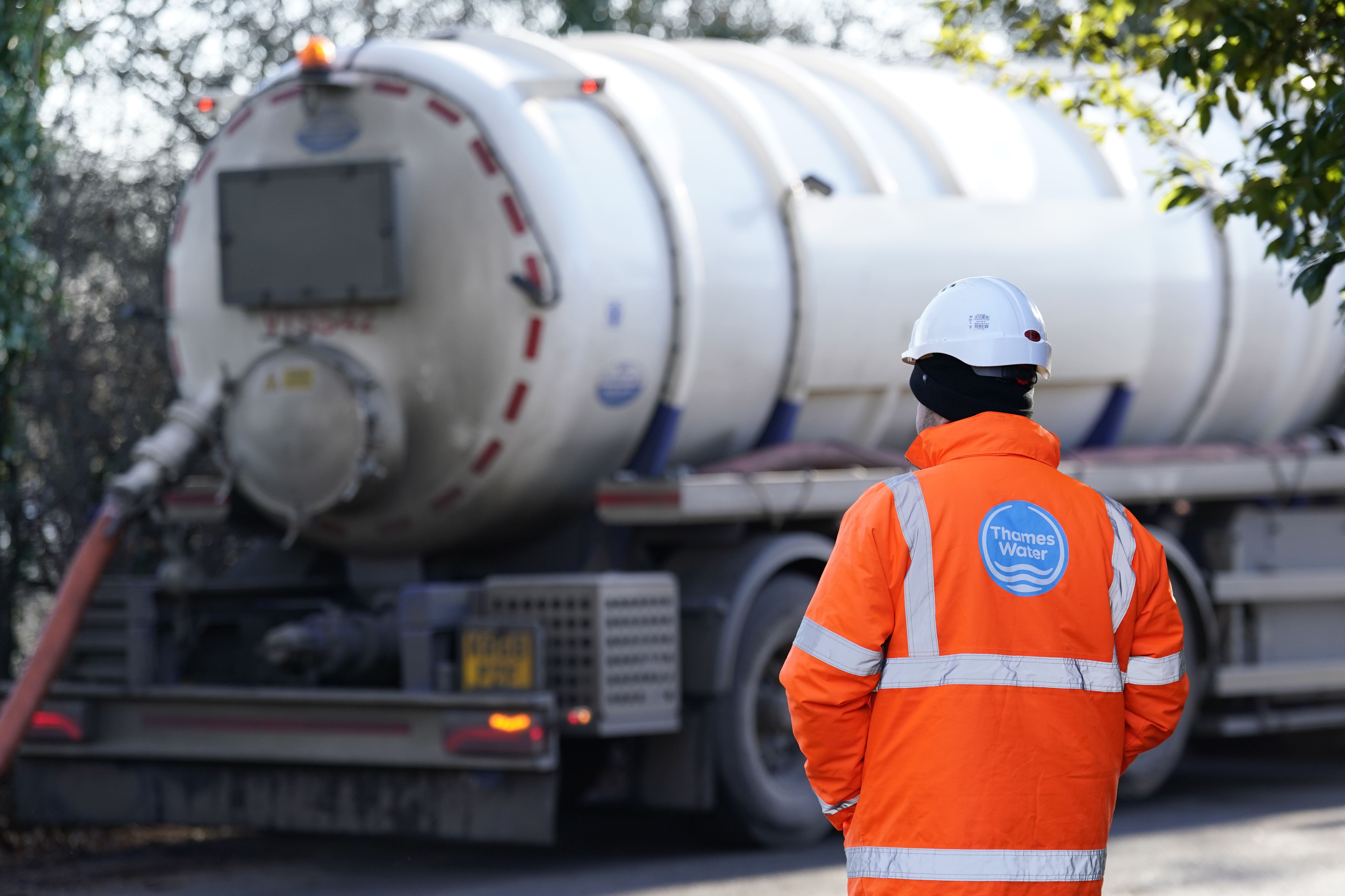 A Thames Water employee with a tanker (PA)