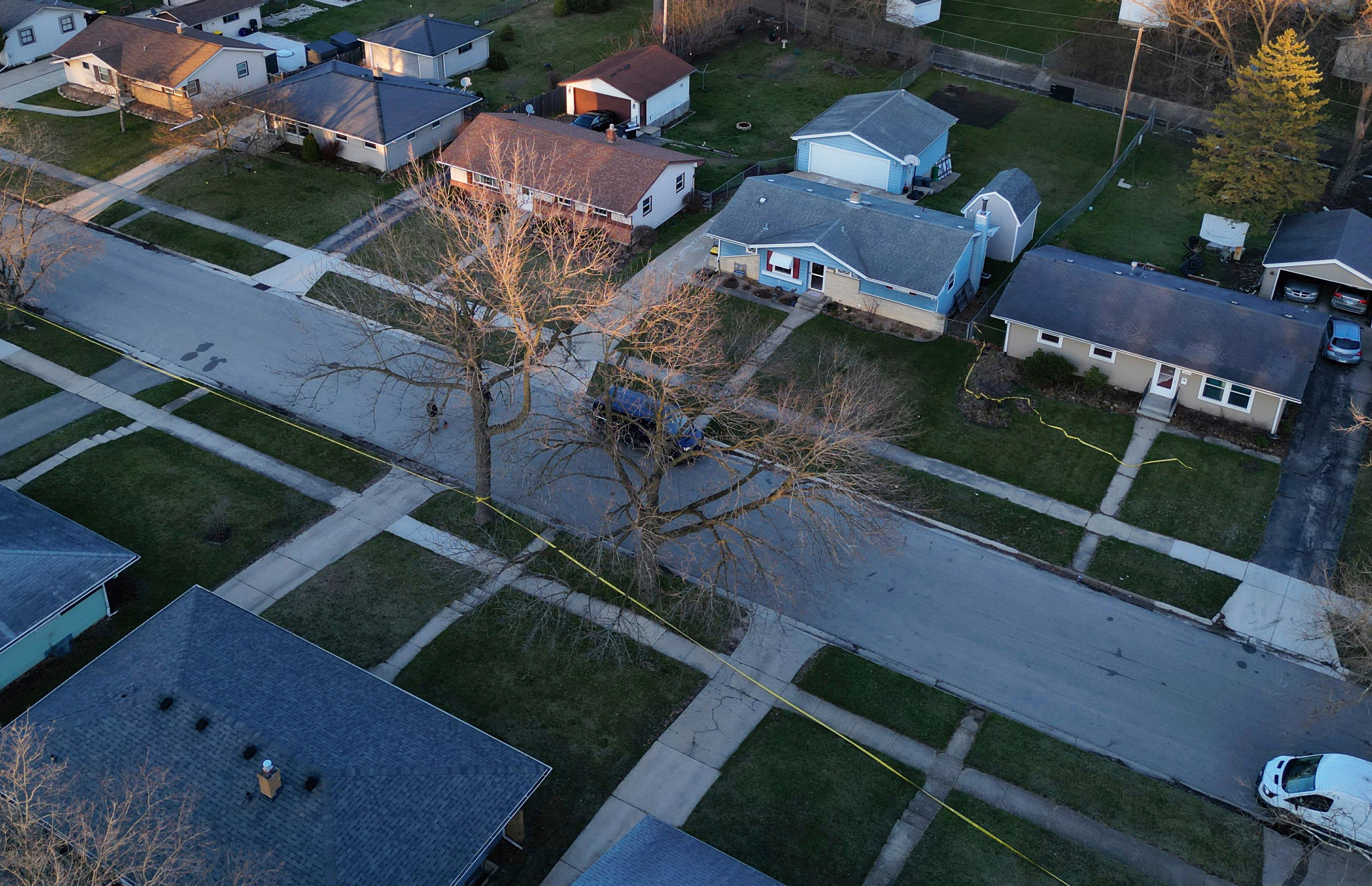 Police tape surrounds many homes as police investigate a mass stabbing along the 2300 block of Holmes Street on March 27, 2024, in Rockford, Illinois