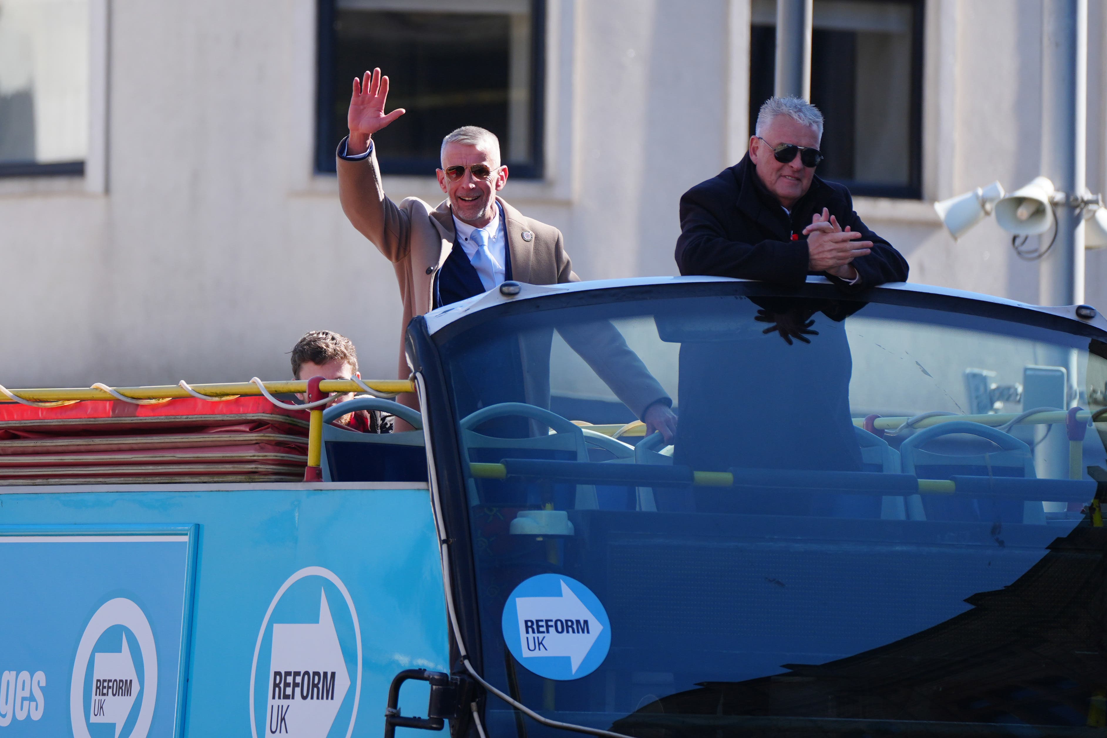 Mark Butcher, left, the Reform UK candidate for the forthcoming Blackpool South by-election, and Lee Anderson on an open top bus during a campaign event (Peter Byrne/PA)