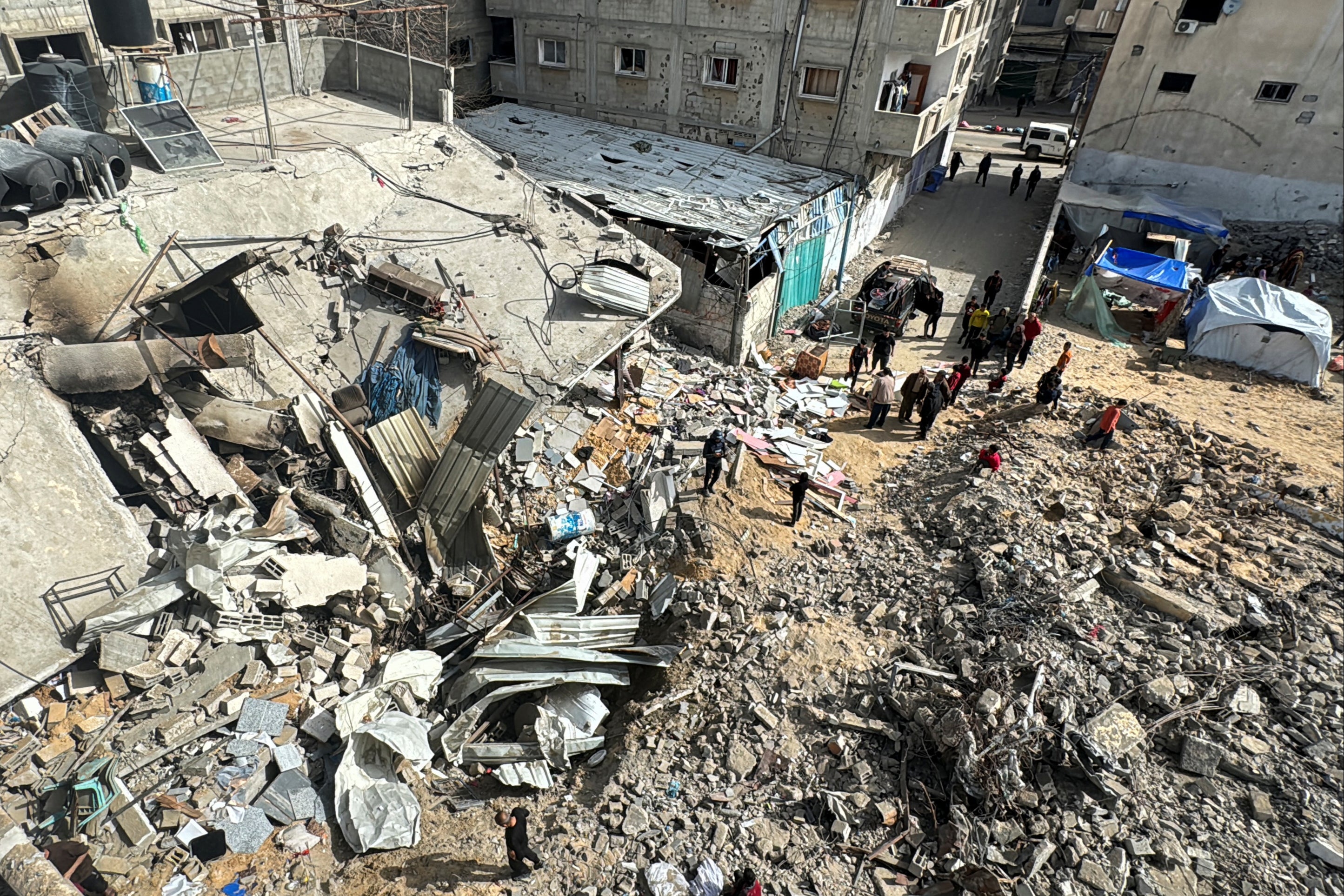 Palestinians inspect the site of an Israeli strike in Rafah, southern Gaza