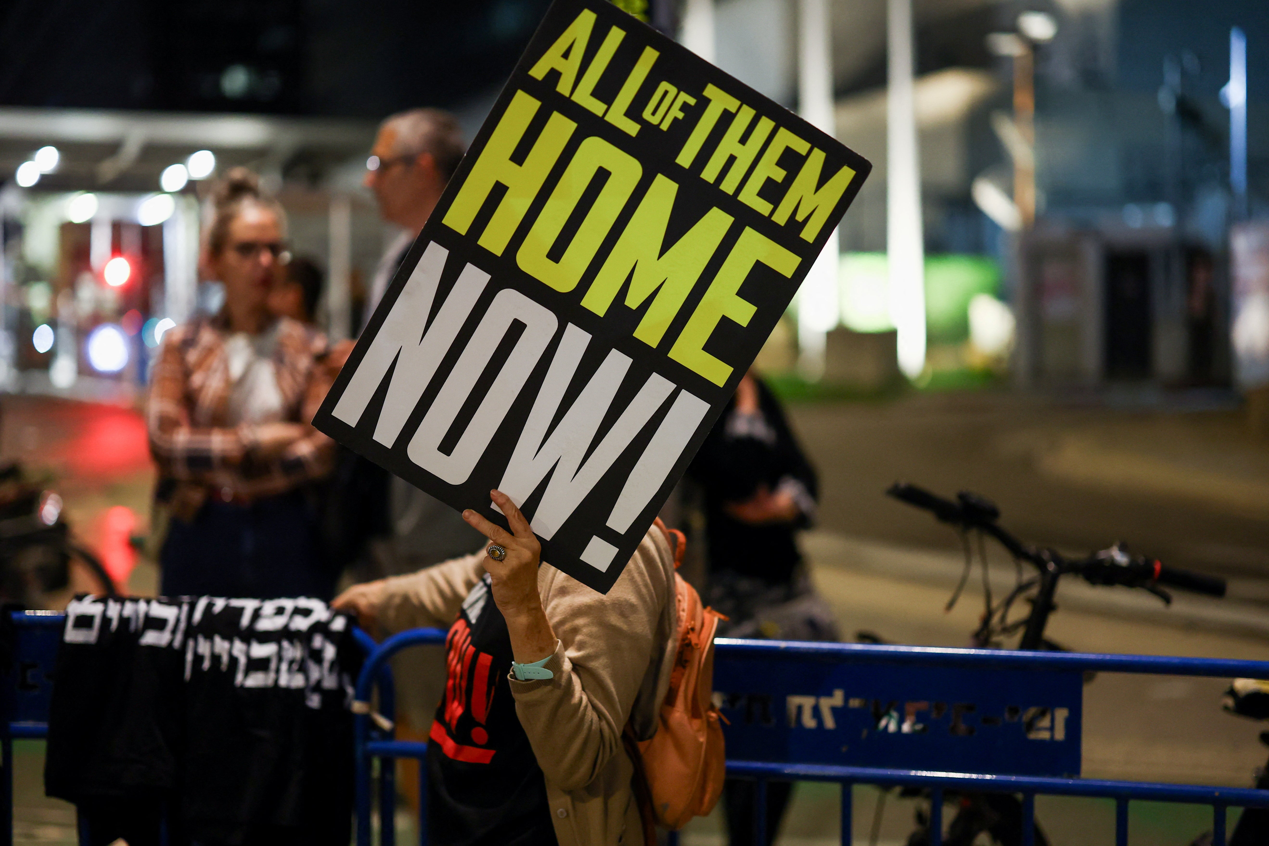 A demonstrator holds a placard during a protest in Tel Aviv demanding the release of hostages taken in the 7 October attack