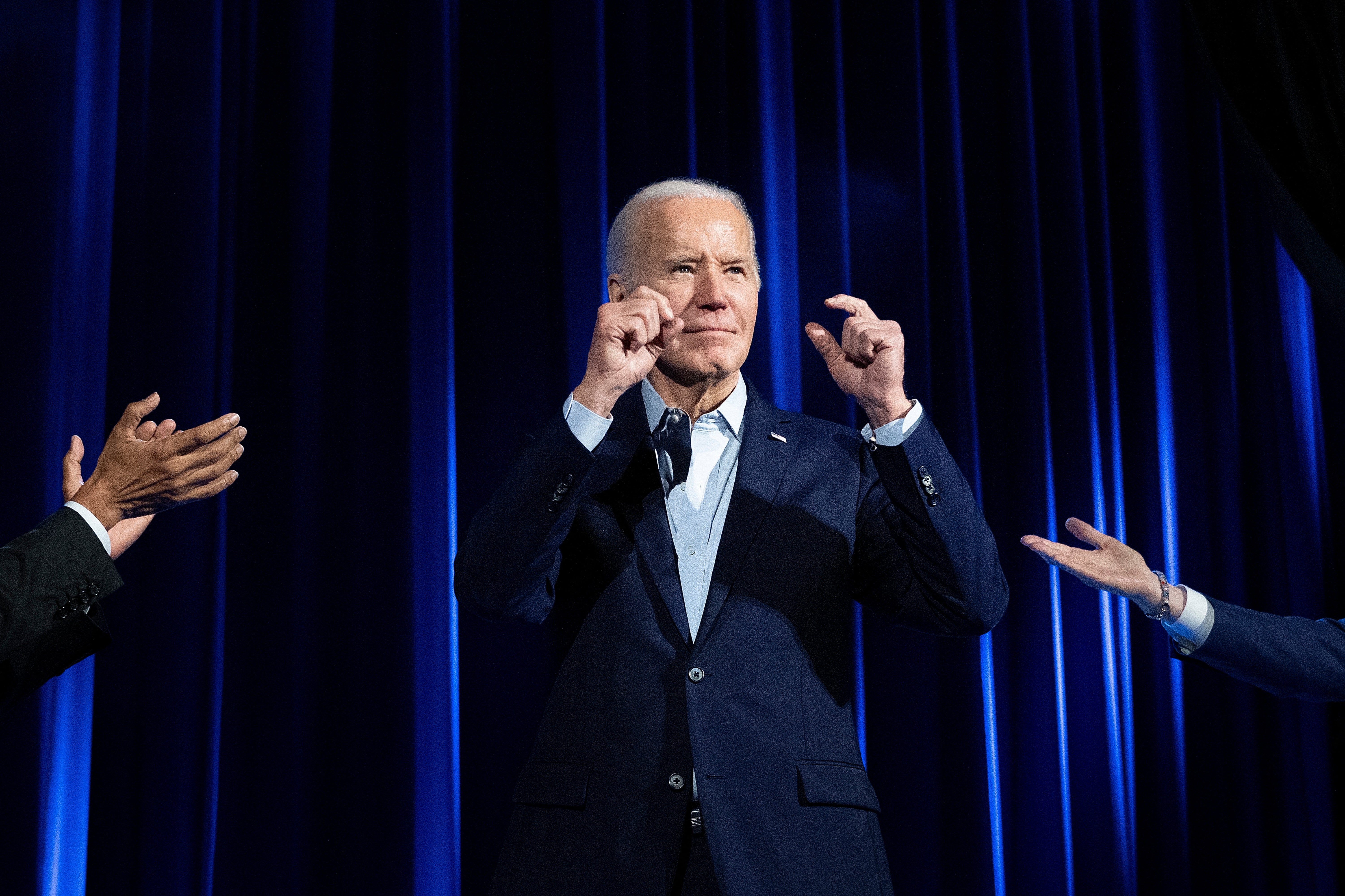 Former US President Barack Obama (L) and former US President Bill Clinton (R) cheer for US President Joe Biden