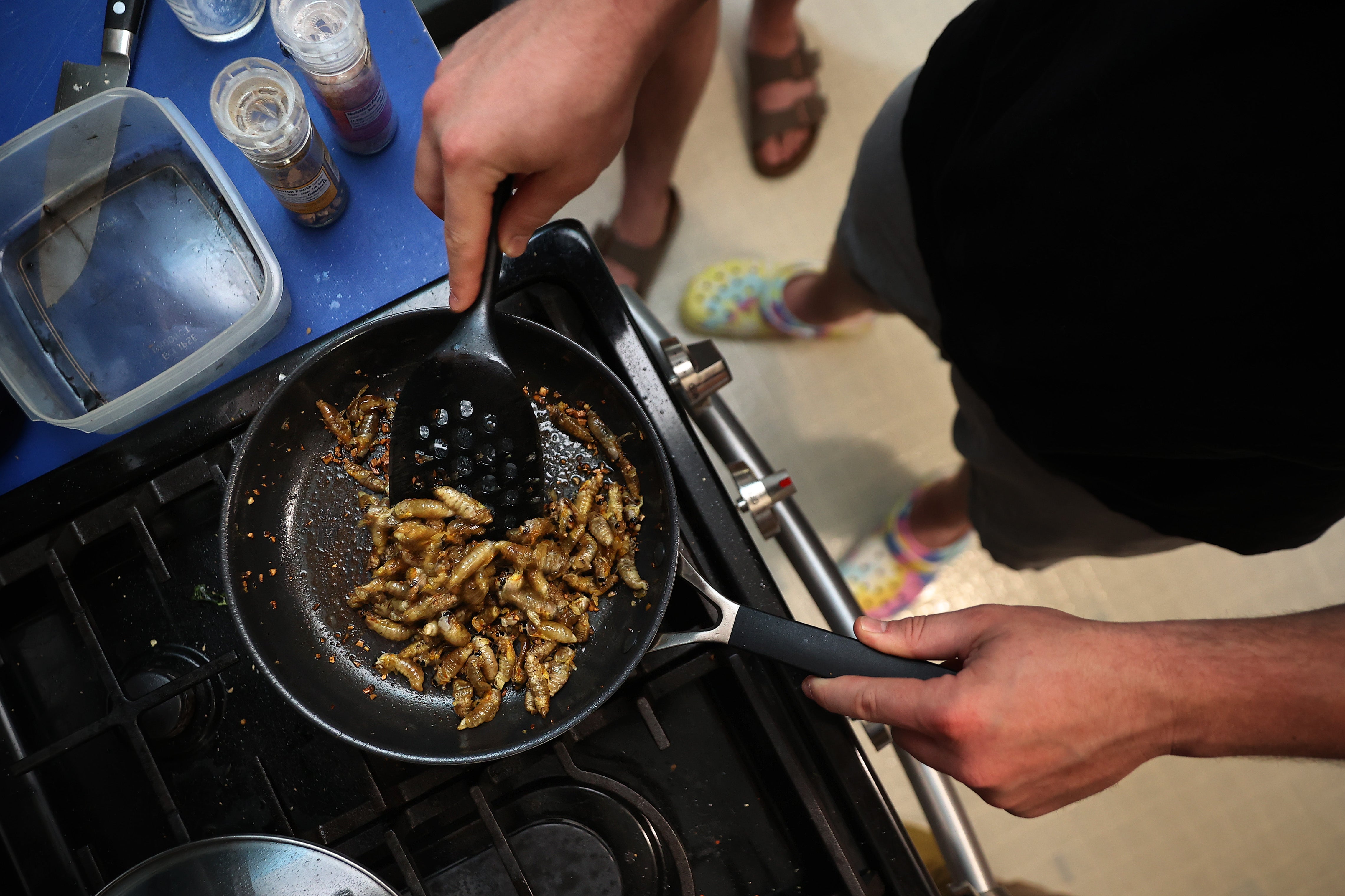 A person cooks cicadas in Maryland in 2021. Enthusiasts are set to celebrate this year’s mass emergence by attending festivals, tracking the insects on apps and enjoying them as snacks