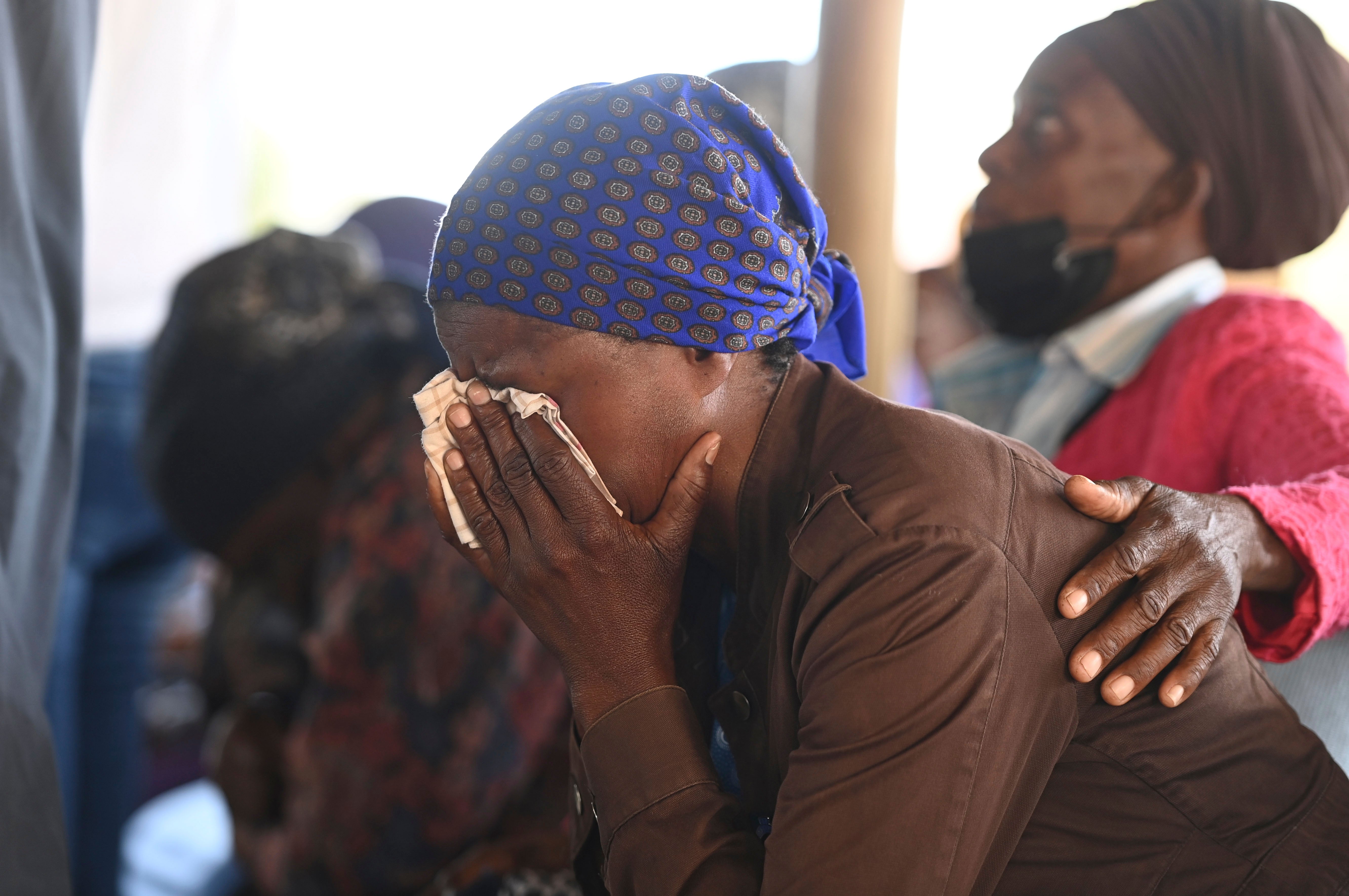 Relatives of the bus crash victims gather in a village near Gaborone, Botswana, where the trip departed from