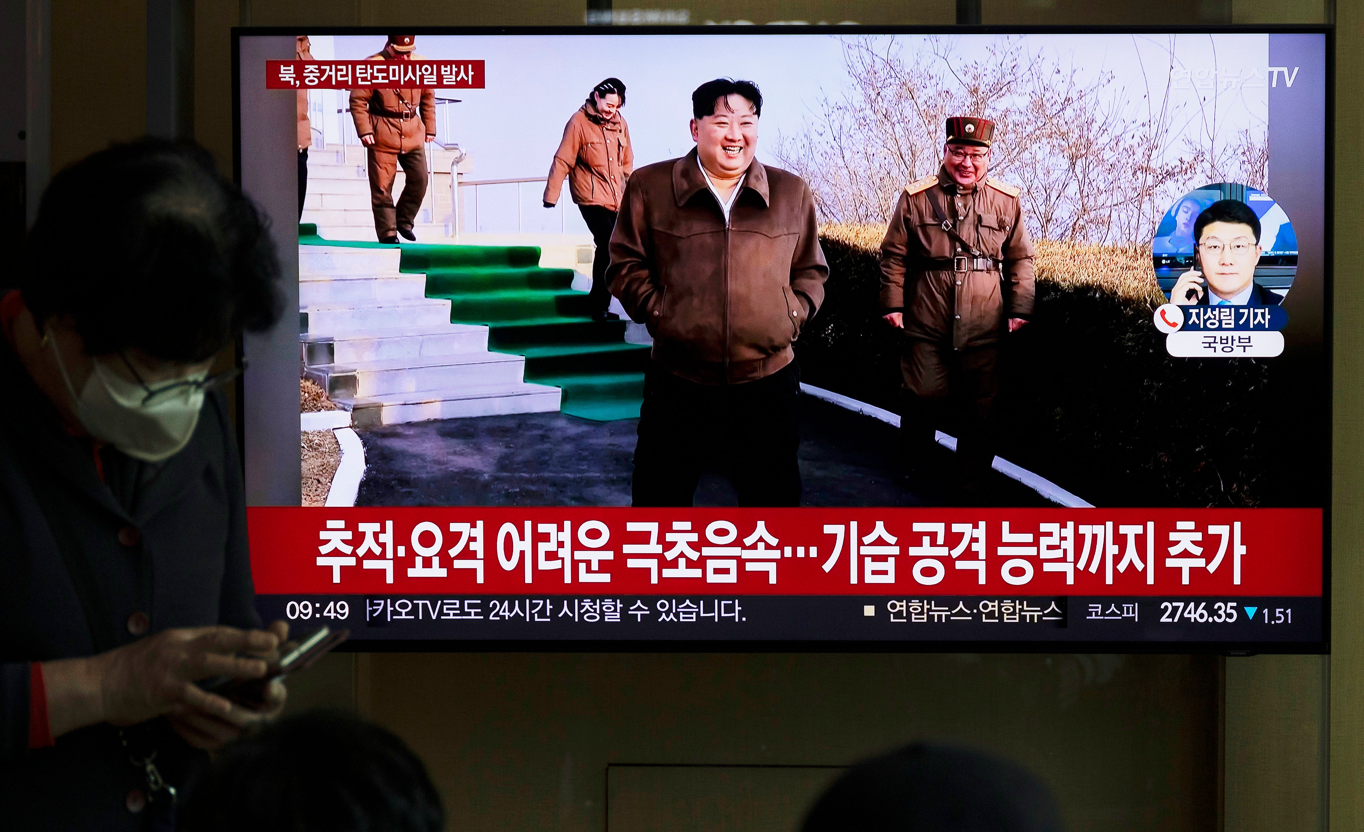 People watch a news segment pertaining to a North Korean missile launch, at a station in Seoul, South Korea