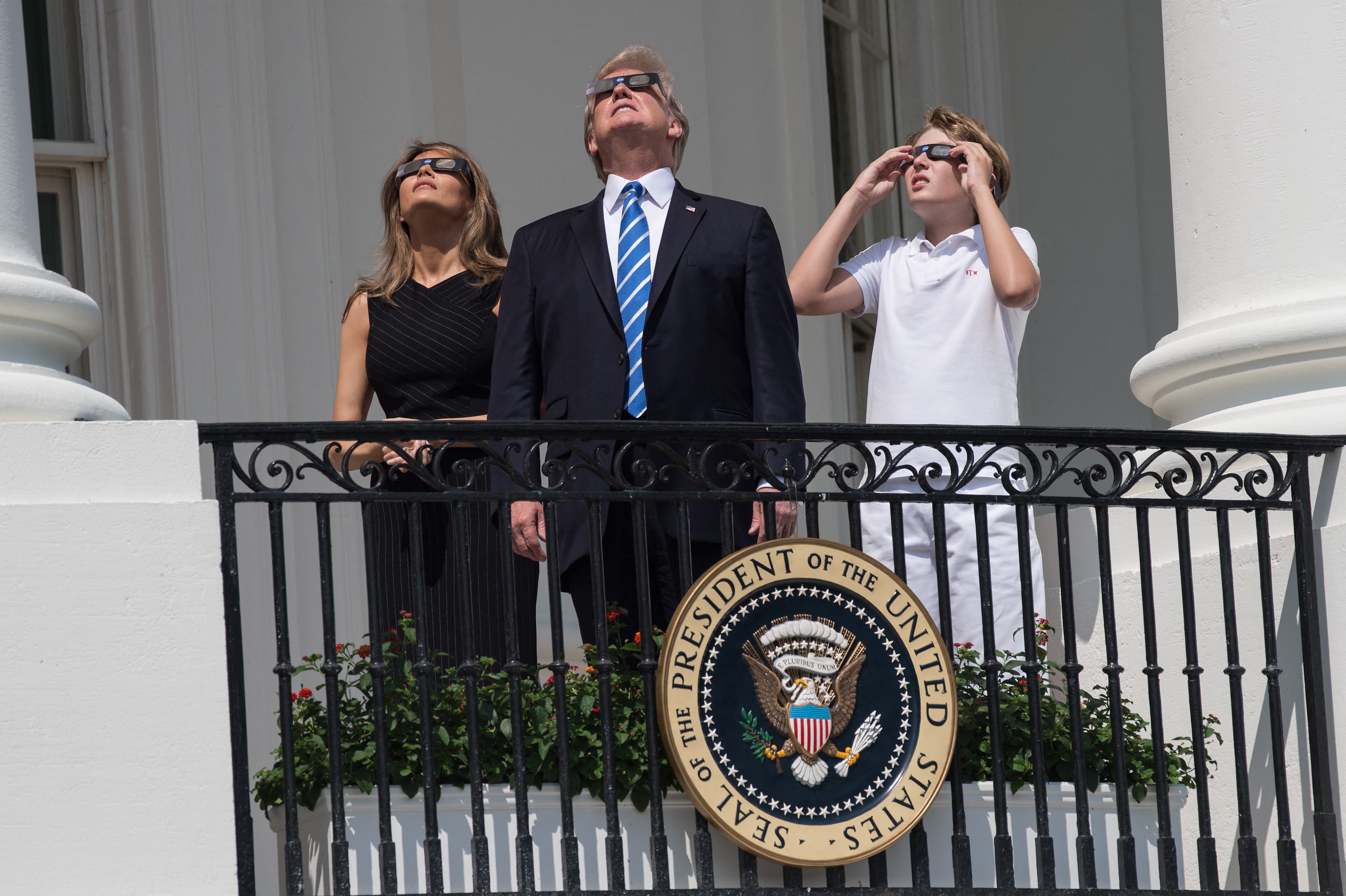 Barron, Melania and Donald Trump on the balcony of the White House during the 2017 eclipse