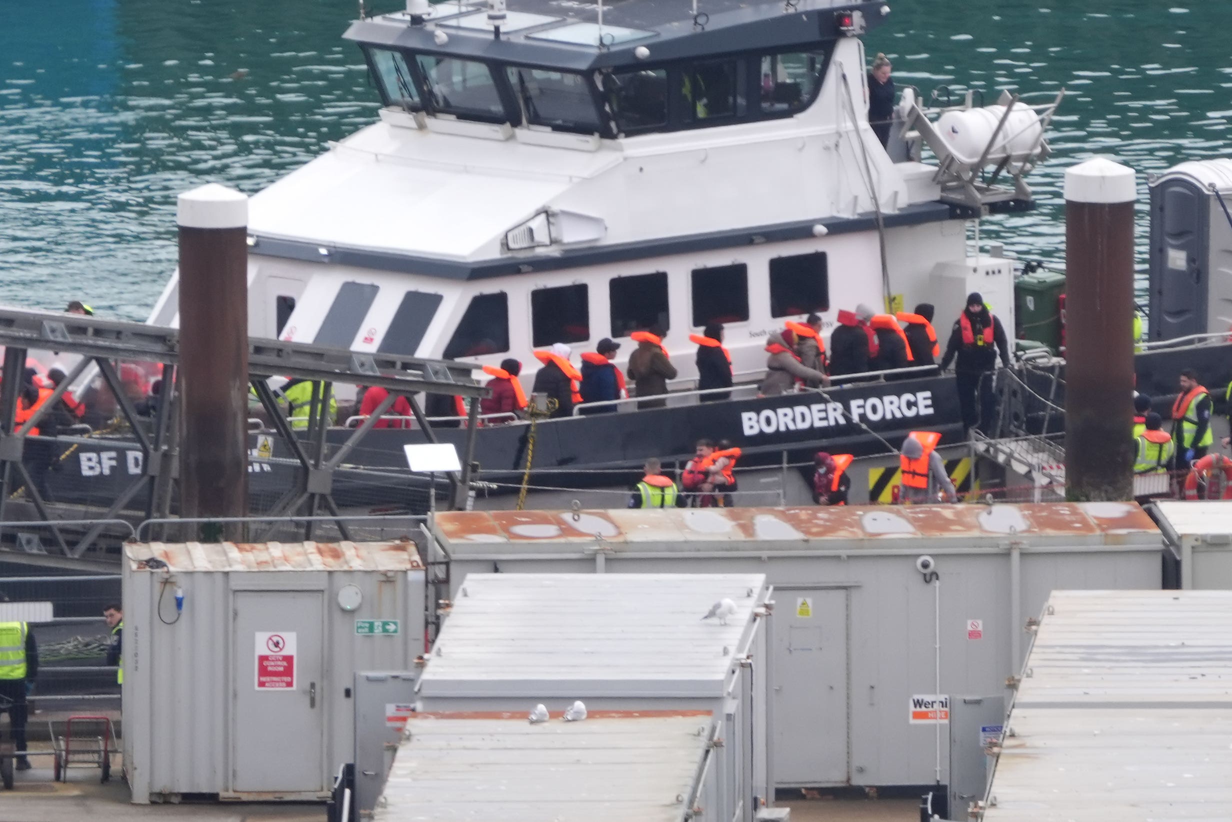 A group of people thought to be migrants are brought in to Dover, Kent, from a Border Force vessel (PA)