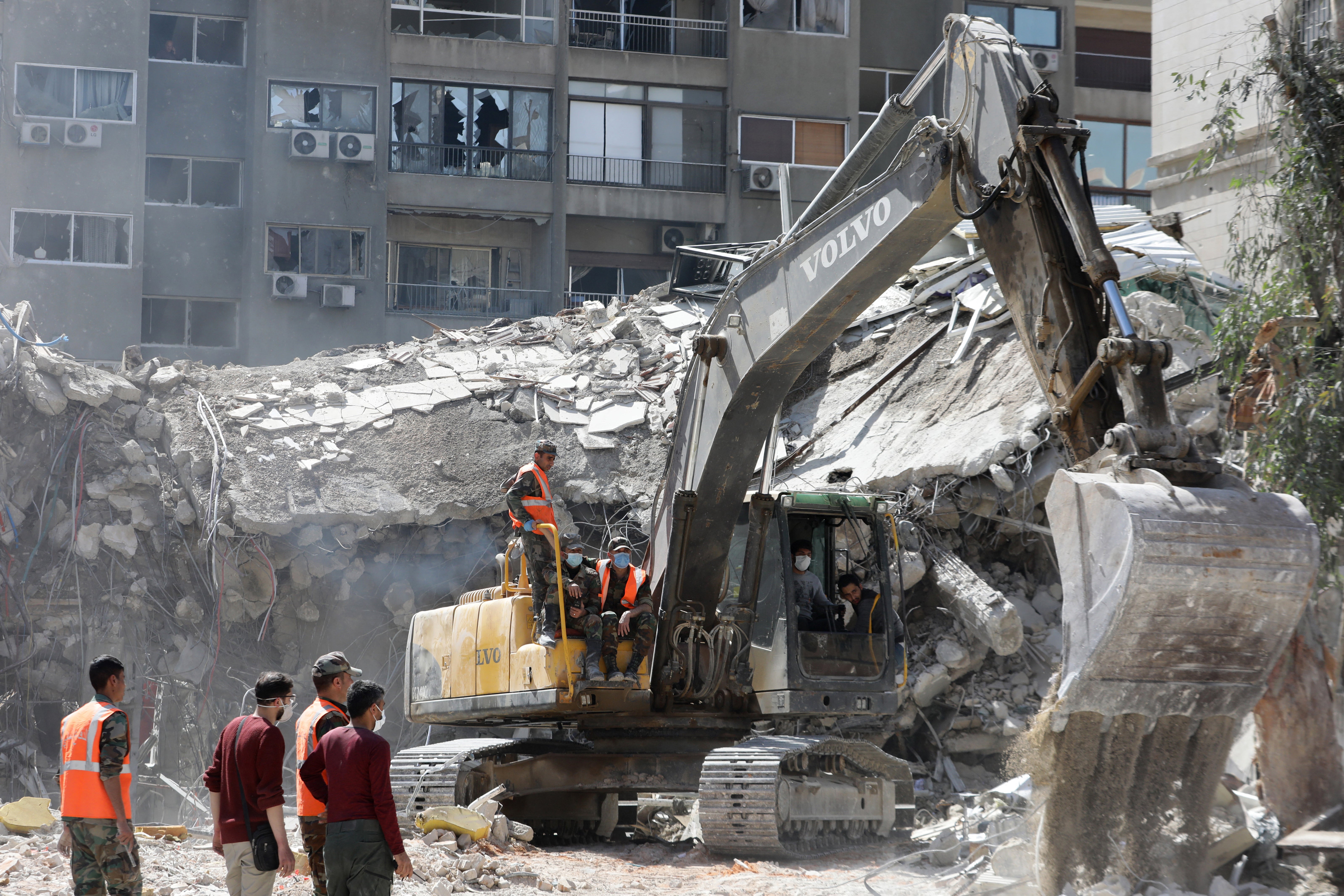 Rescue workers search the rubble of a building used by the Iranian embassy in Damascus after the airstrike