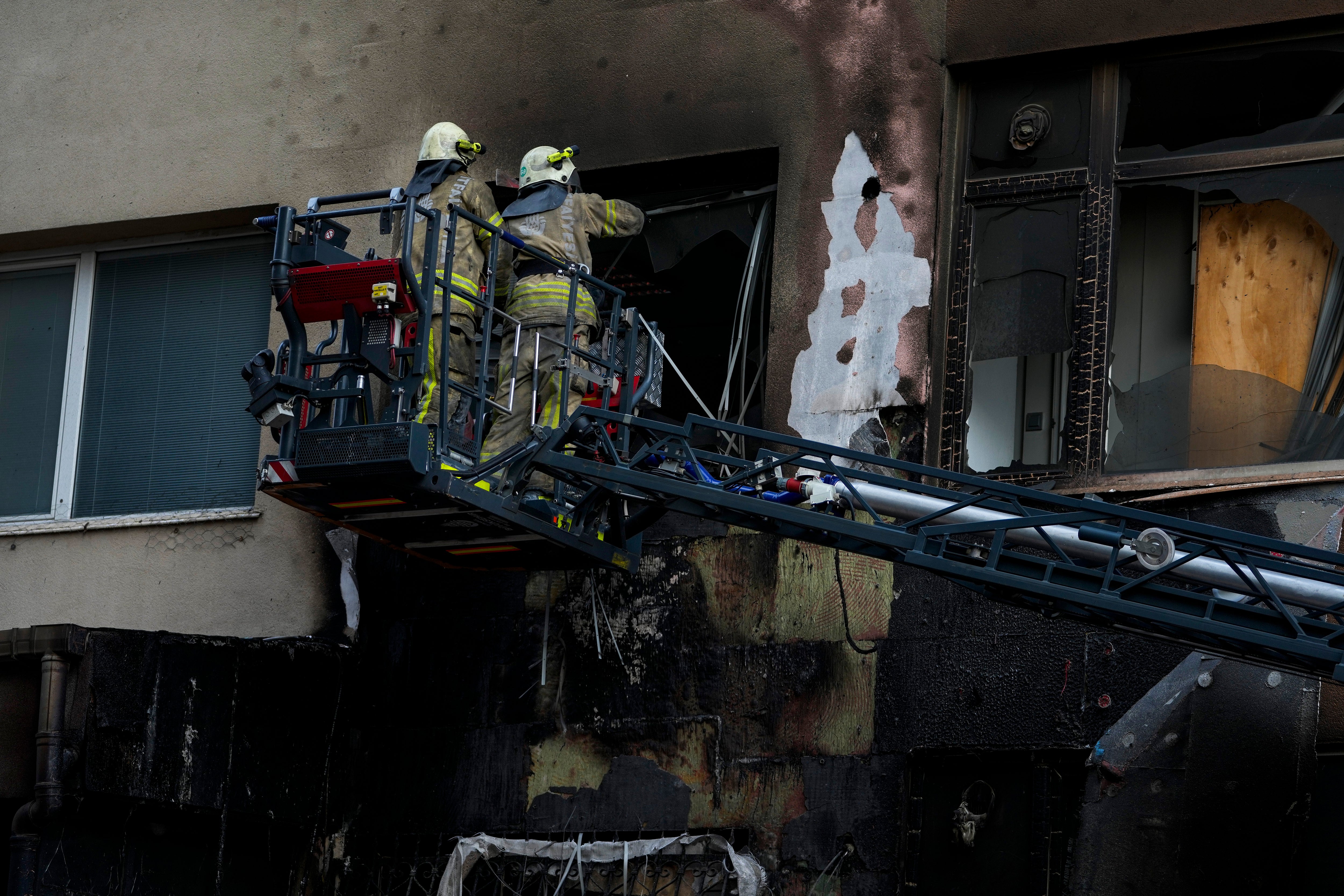 Firefighters work in the aftermath of a fire in a nightclub in Istanbul, Turkey