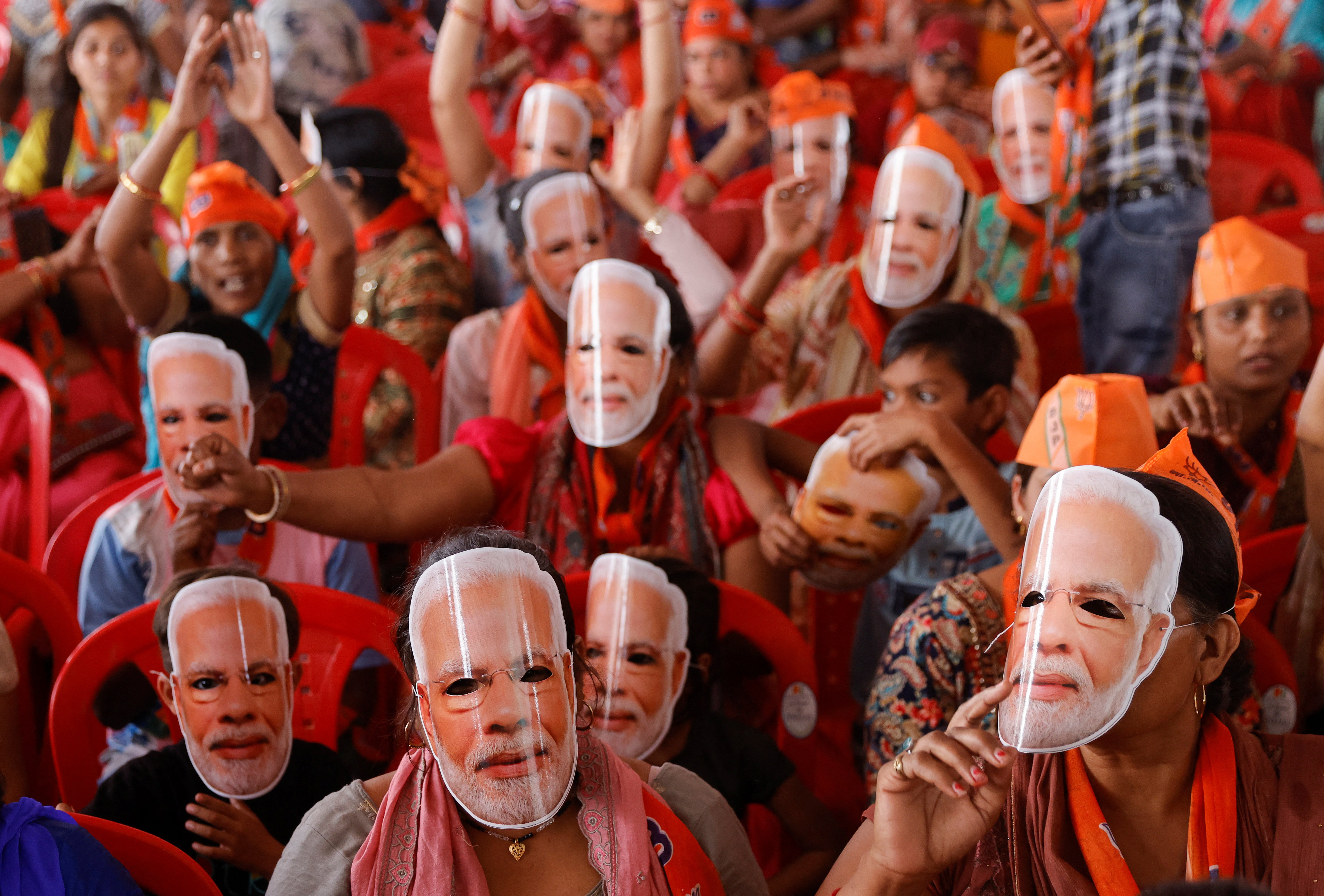 Supporters of Narendra Modi’s BJP wearing masks of his face at an election rally in Meerut on Sunday