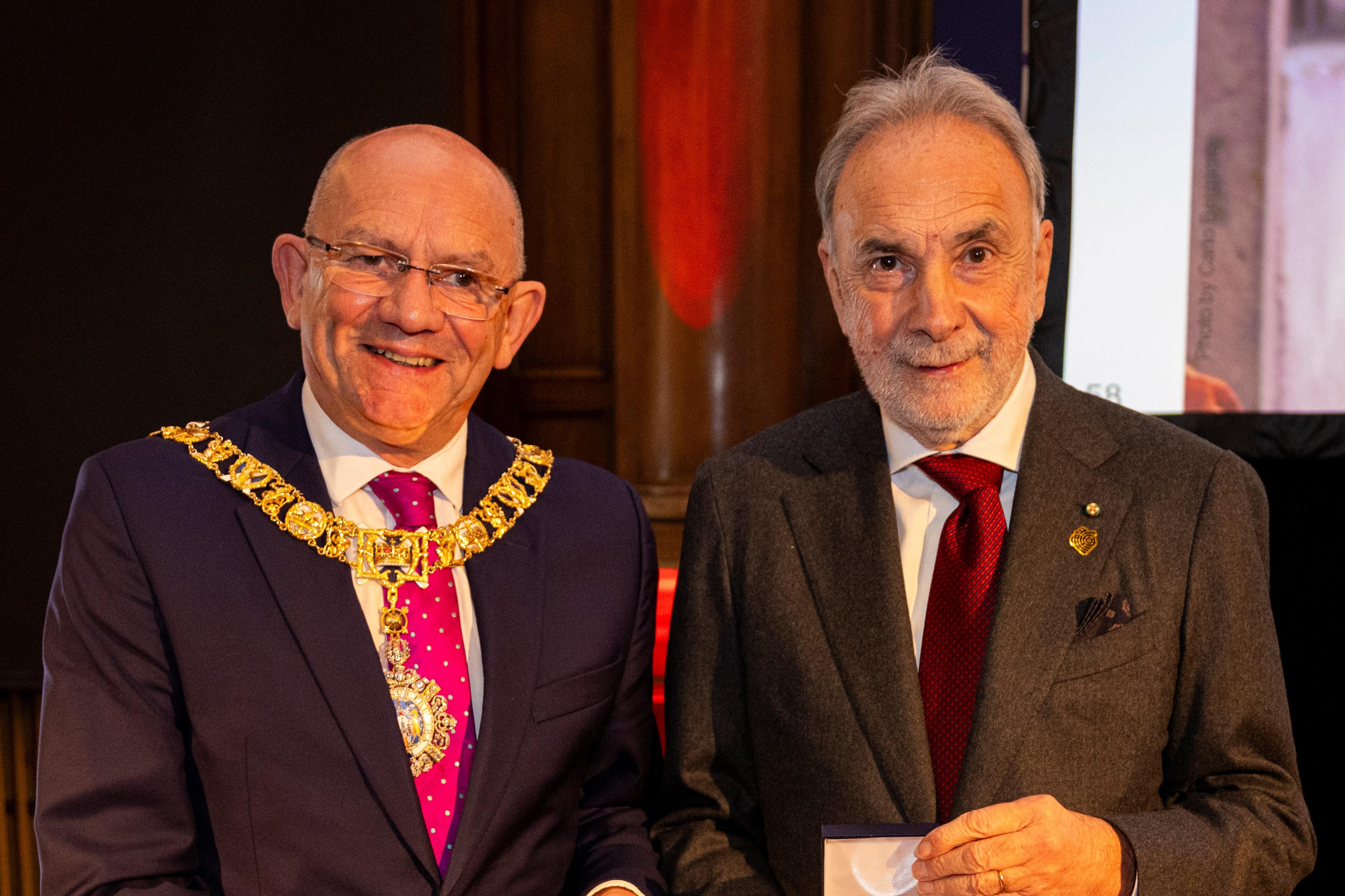 The medal was awarded to the institute’s director Giuseppe Remuzzi, right (Duncan McGlynn/PA)