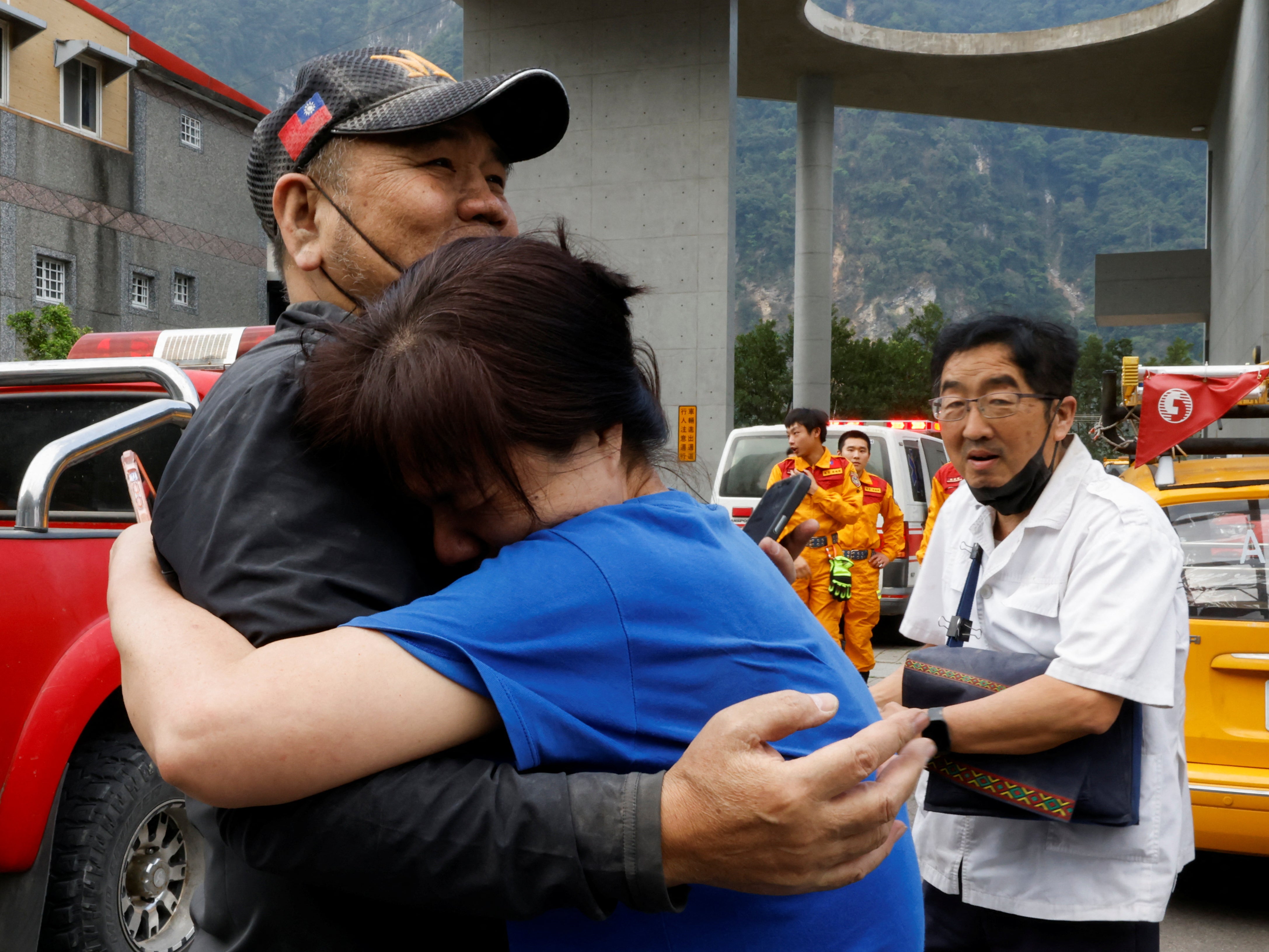 A relative hugs a man who was rescued from a remote area, following the earthquake, in Hualien