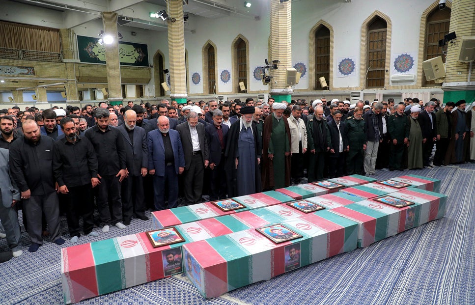 Supreme Leader Ayatollah Ali Khamenei, center with black turban, leads a prayer over the flag-draped coffins of the Revolutionary Guards members who were killed in an airstrike widely blamed on Israel in Syria on Monday