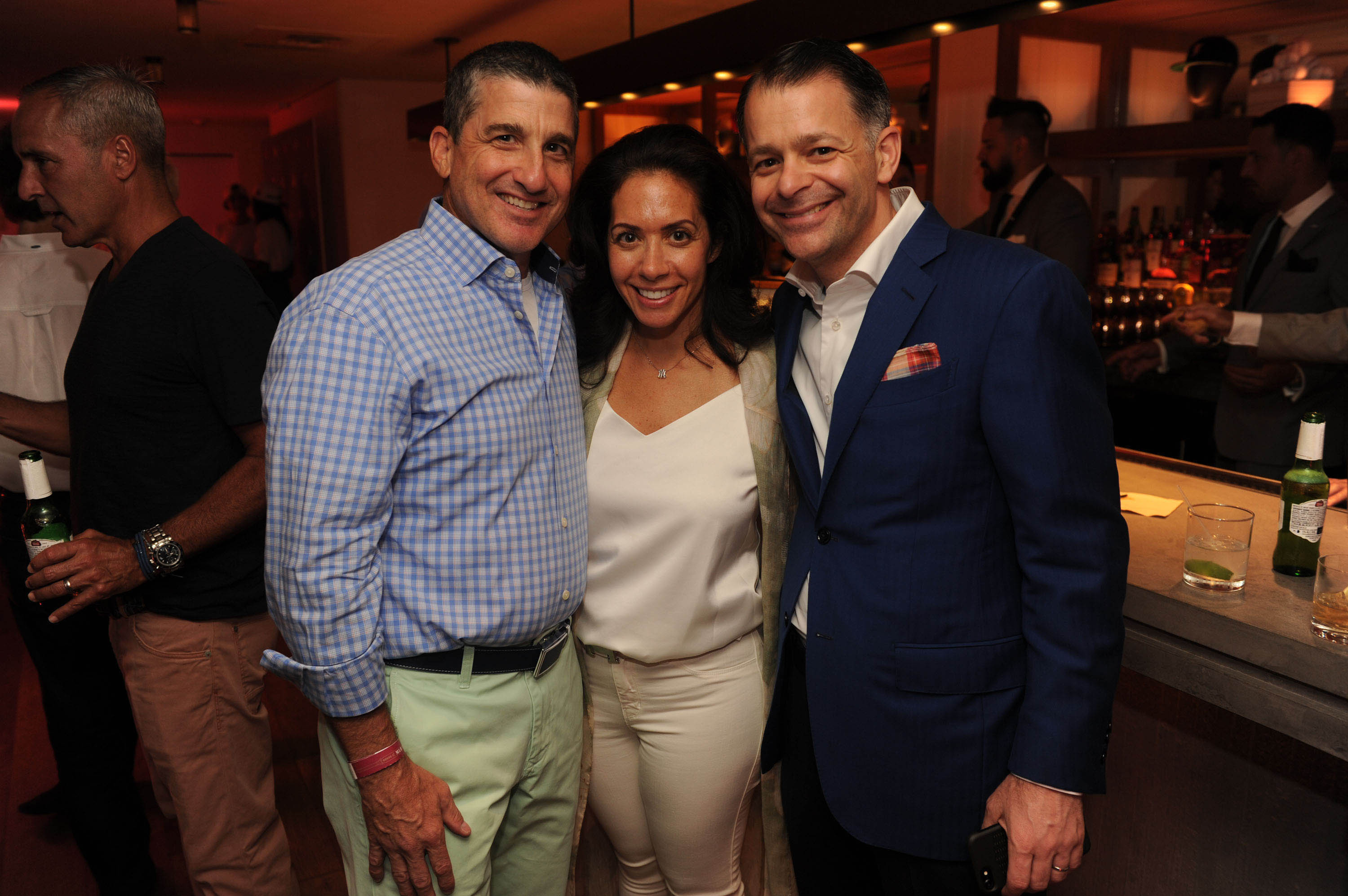 Cathy Tusiani in the centre with her husband, Michael Tusiani on the right at a Miami Beach party in 2017