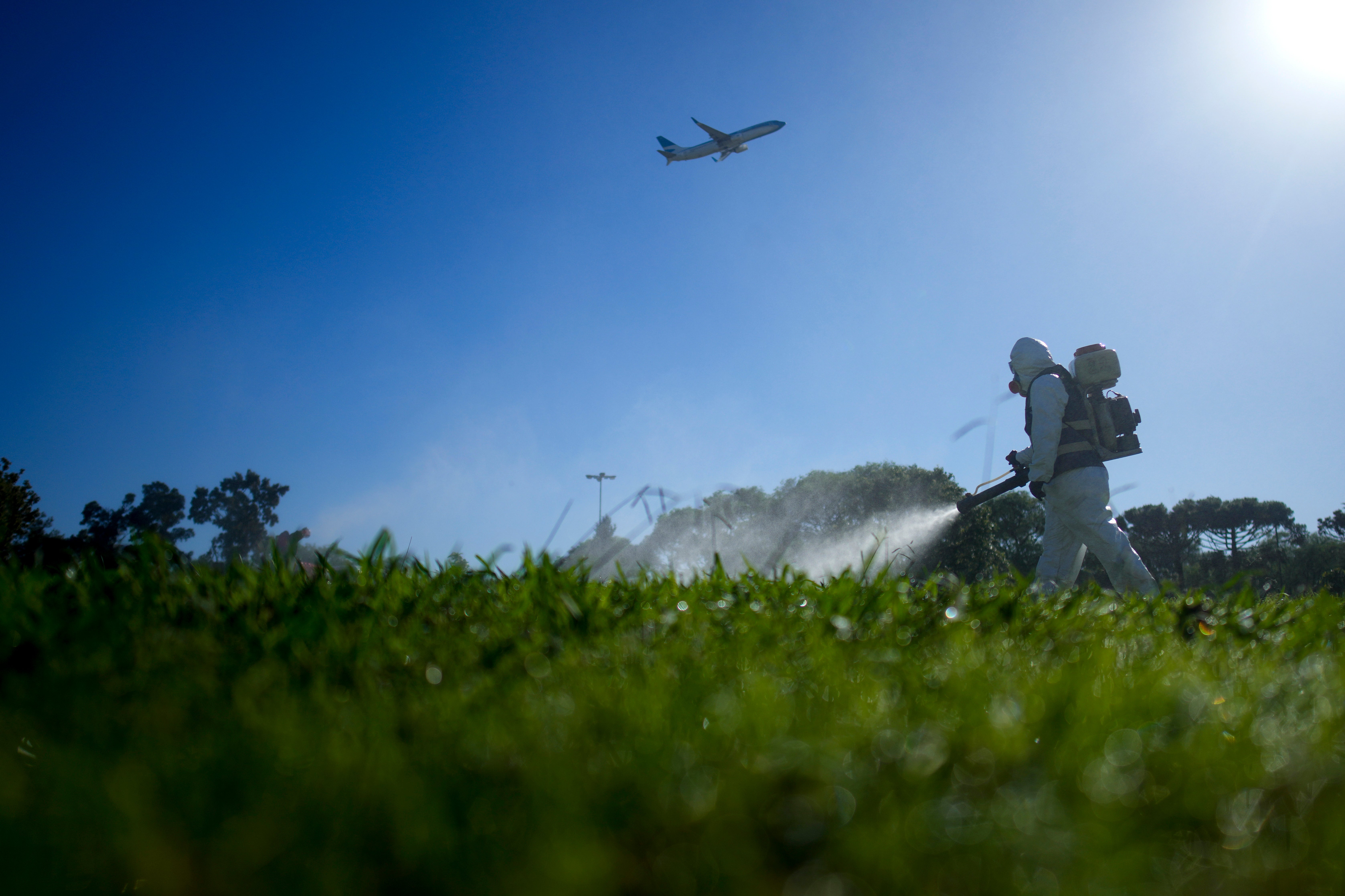 A public health worker fumigates as part of a campaign against dengue-promoting mosquitoes, in Buenos Aires