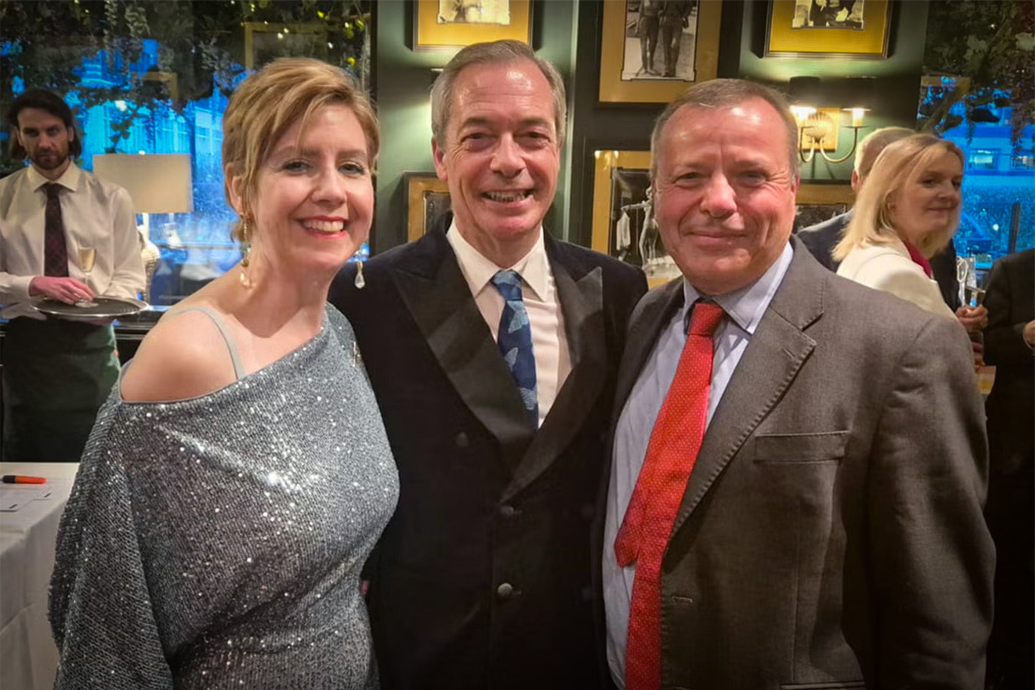 Cheers! Nigel Farage at his birthday party with Aaron Banks, finger-flipping ex-minister Andrea Jenkyns... and who is that in the background?