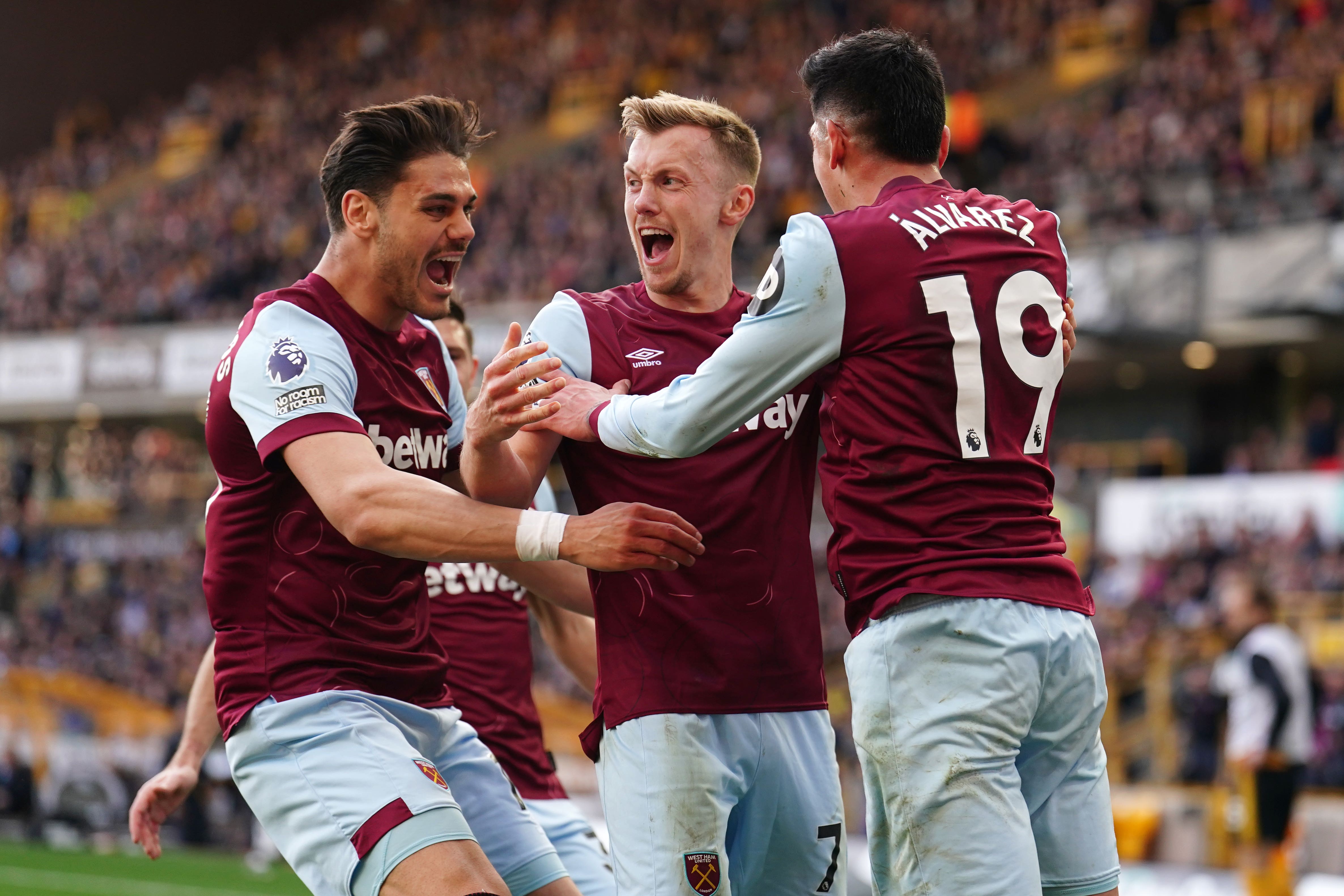 West Ham United’s James Ward-Prowse (centre) celebrates with Konstantinos Mavropanos (left) and Edson Alvarez after scoring their second goal of the game during the Premier League match at Molineux, Wolverhampton. Picture date: Saturday April 6, 2024.