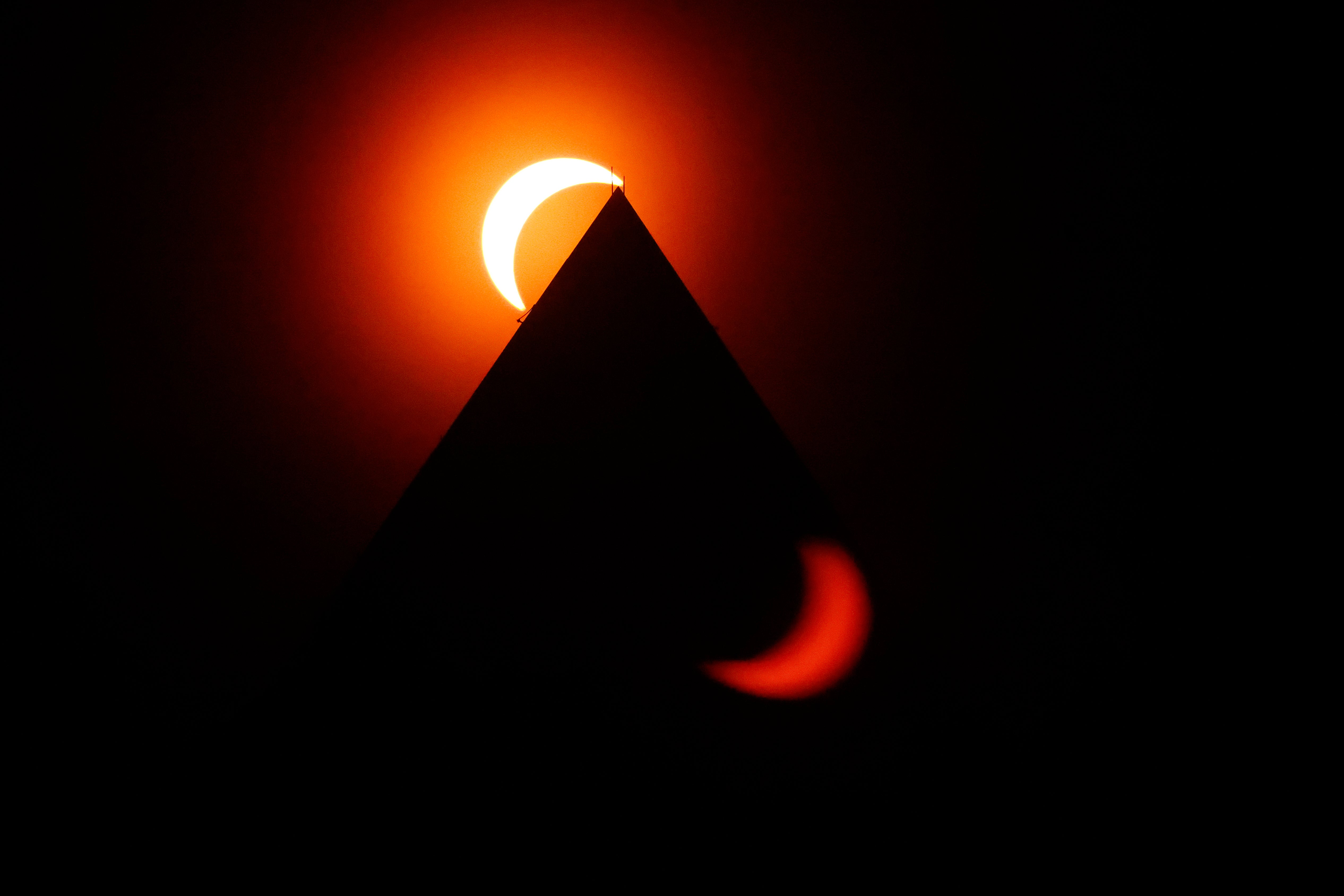 The solar eclipse is seen above the Washington Monument on April 08, 2024 in Washington, DC