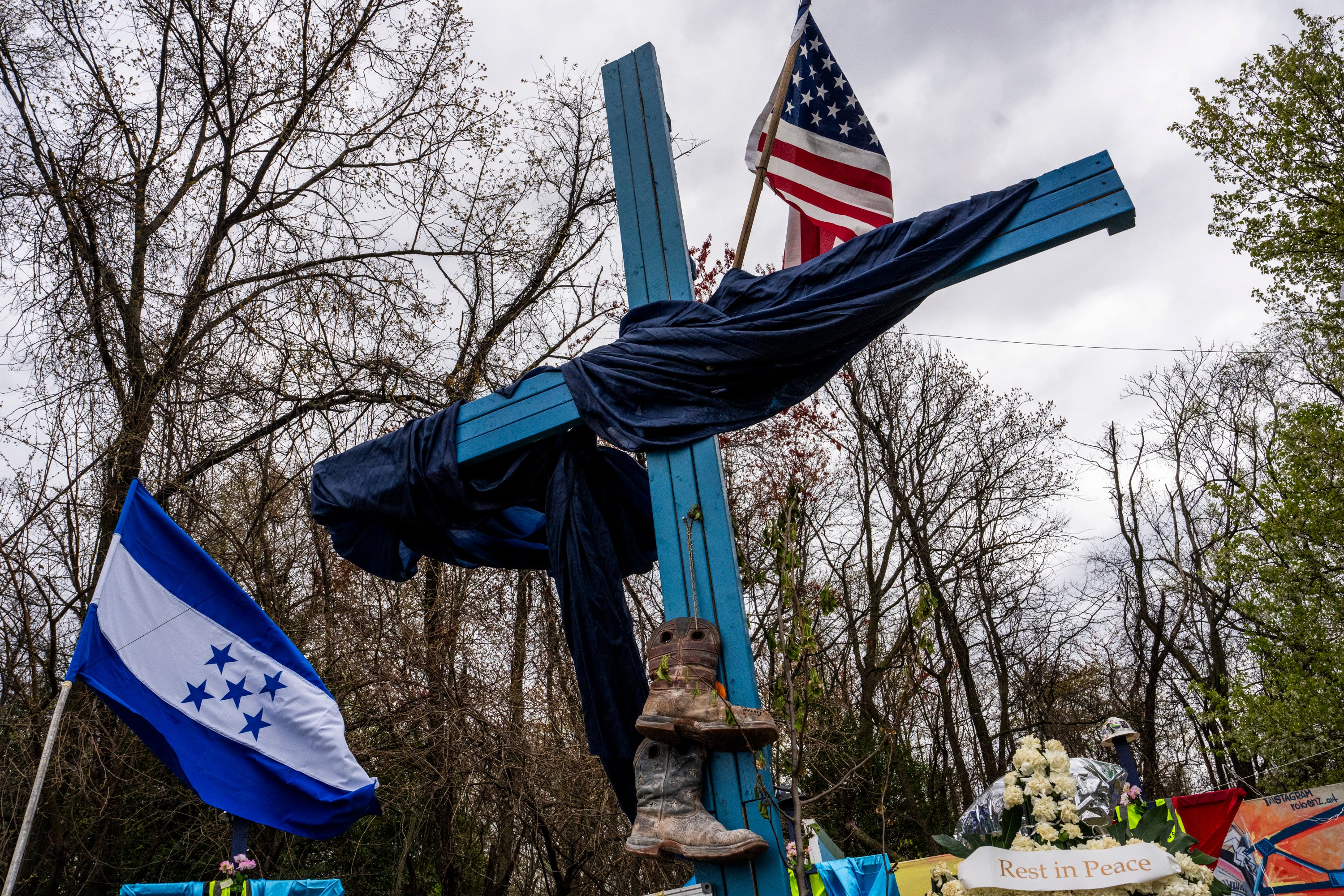 A memorial site to honor the construction workers who lost their lives in the collapse of the Francis Scott Key Bridge sits on the side of the road near the blockade to Fort Armistead Park, in Baltimore