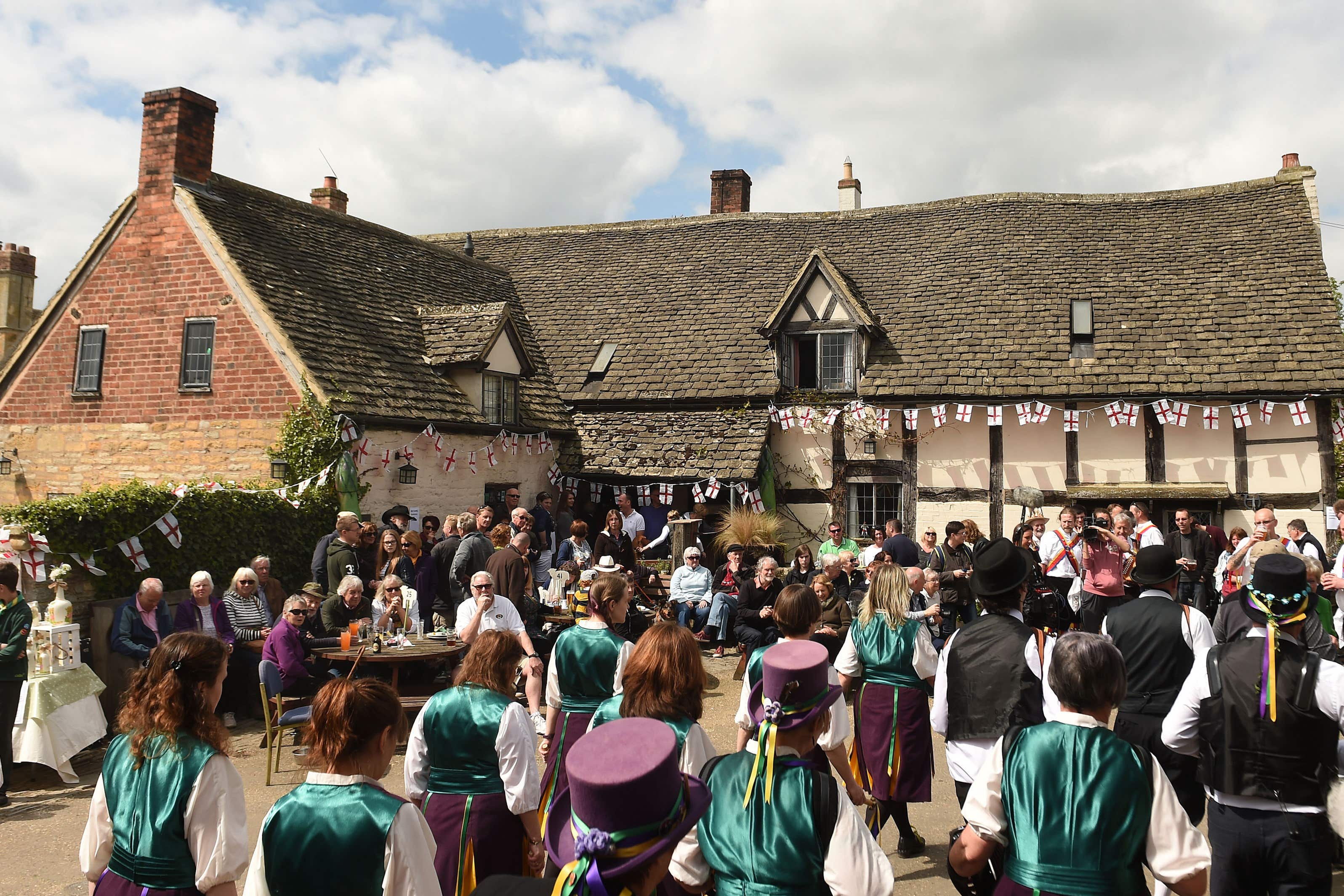 Molly dancers perform as people celebrate St George’s Day and the official start of the asparagus season at the The Fleece Inn in Bretforton, Worcestershire.