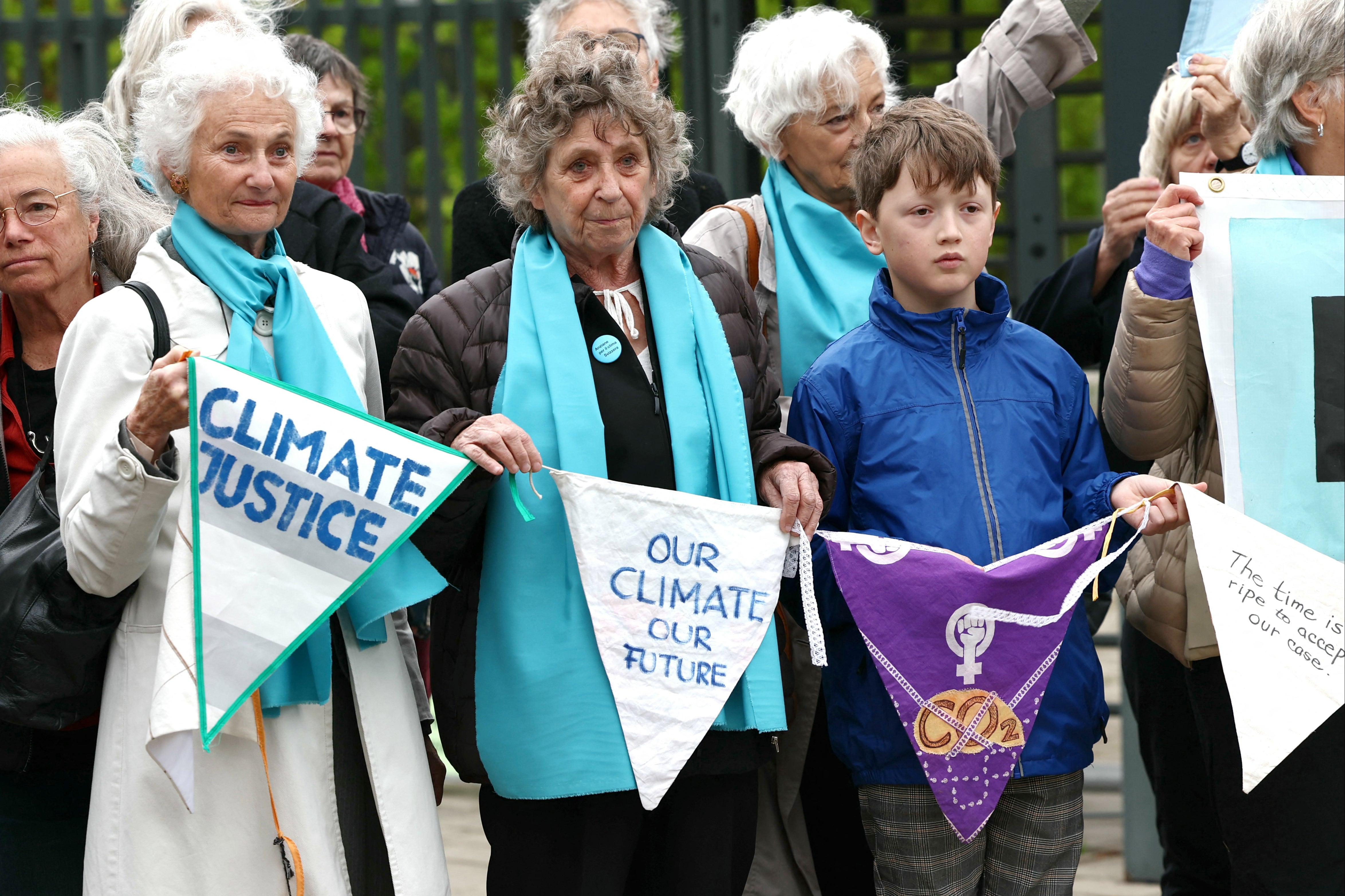 Protesters hold pennants during a rally before the ECHR’s decision