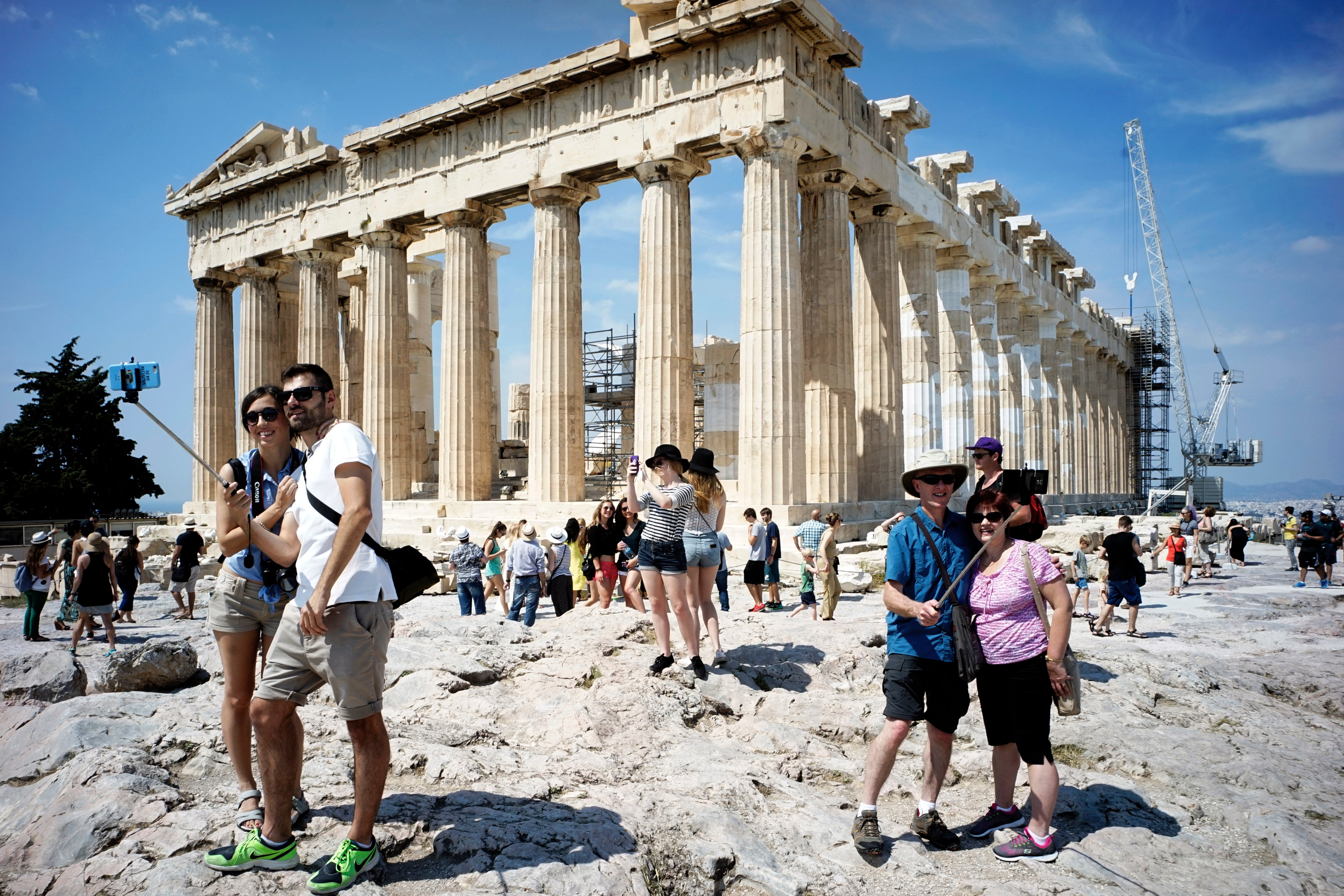 Tourists visit the ancient Acropolis hill in June