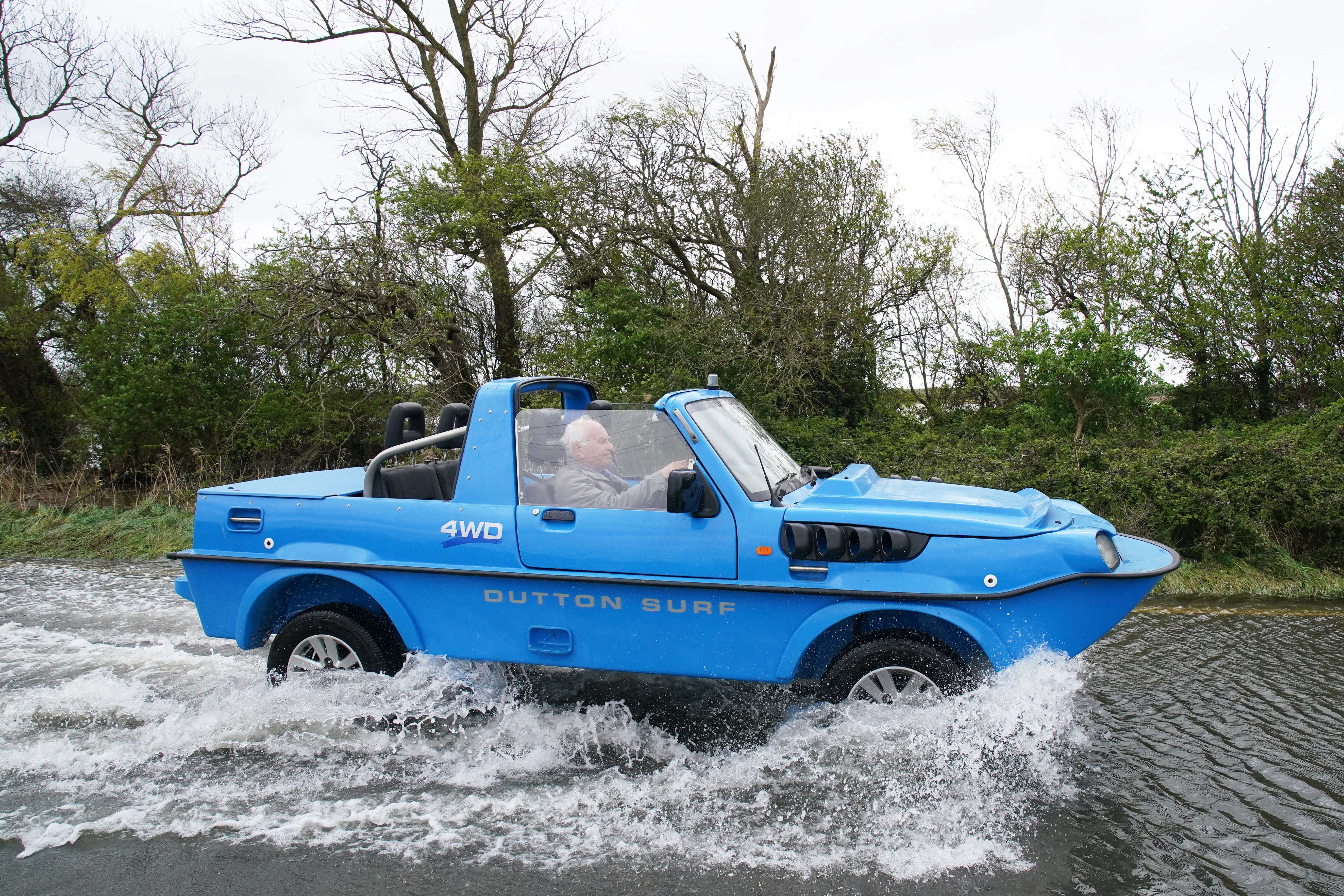 A car drives through floodwater in Littlehampton, West Sussex, after the River Arun burst its banks overnight