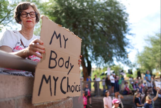 <p>A protestor holds a sign reading ‘My Body My Choice’ at a Women’s March rally  outside the State Capitol on October 8, 2022 in Phoenix, Arizona.</p>