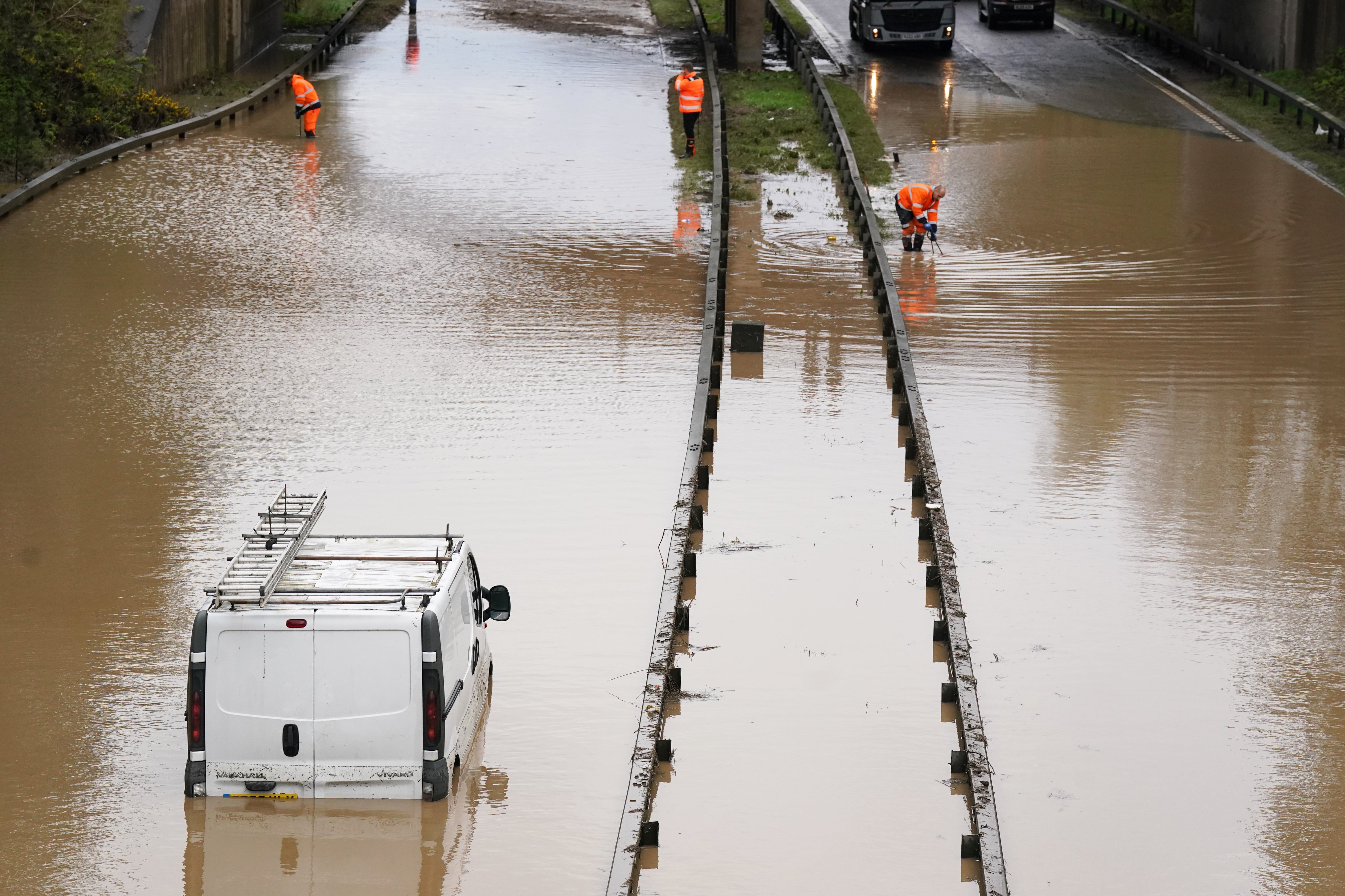 A car is stranded in floodwater on the A189 Spine Road near Blyth, Northumberland, in the wake of Storm Kathleen