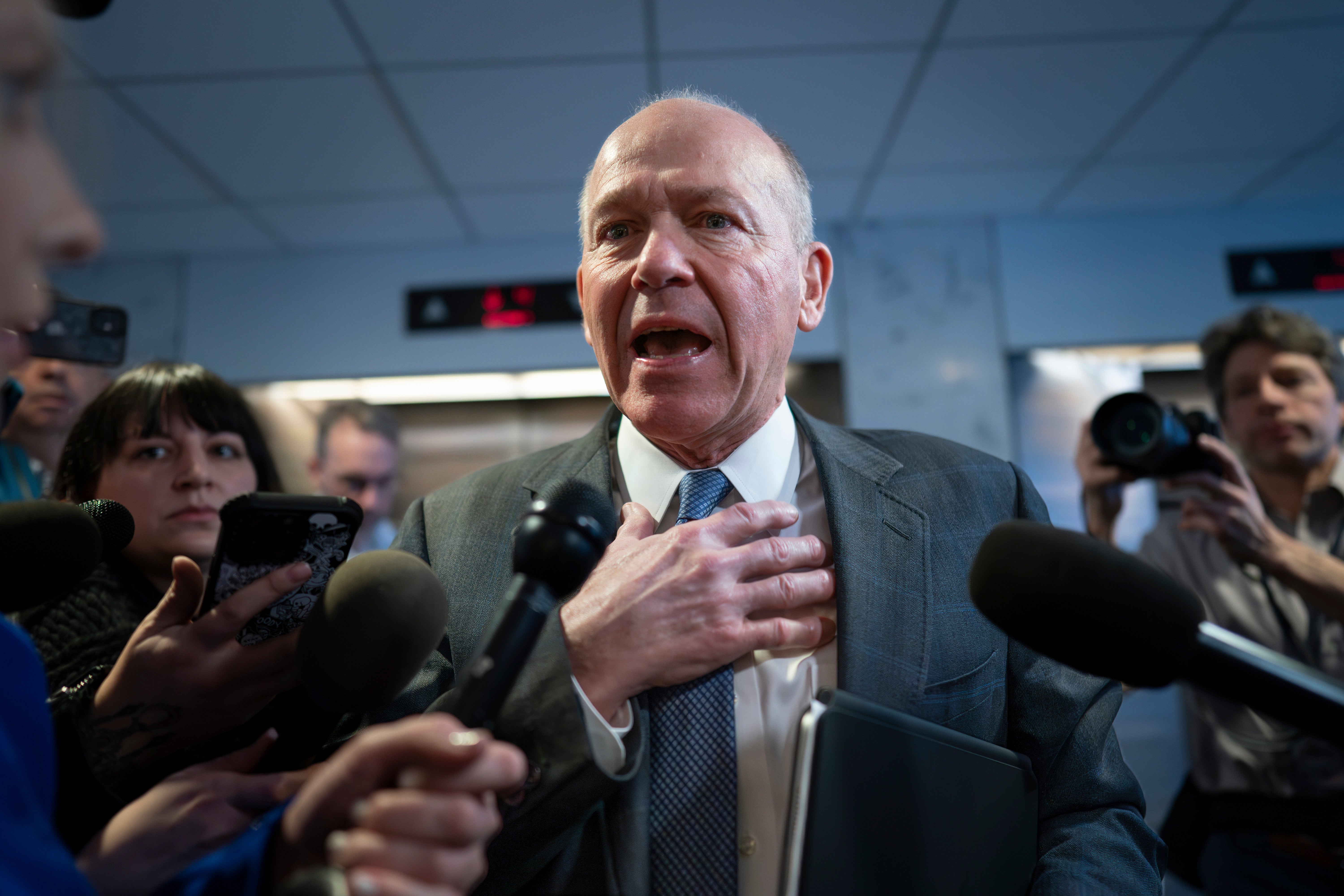 Former Boeing CEO David Calhoun is mobbed by reporters after speaking at the US Senate