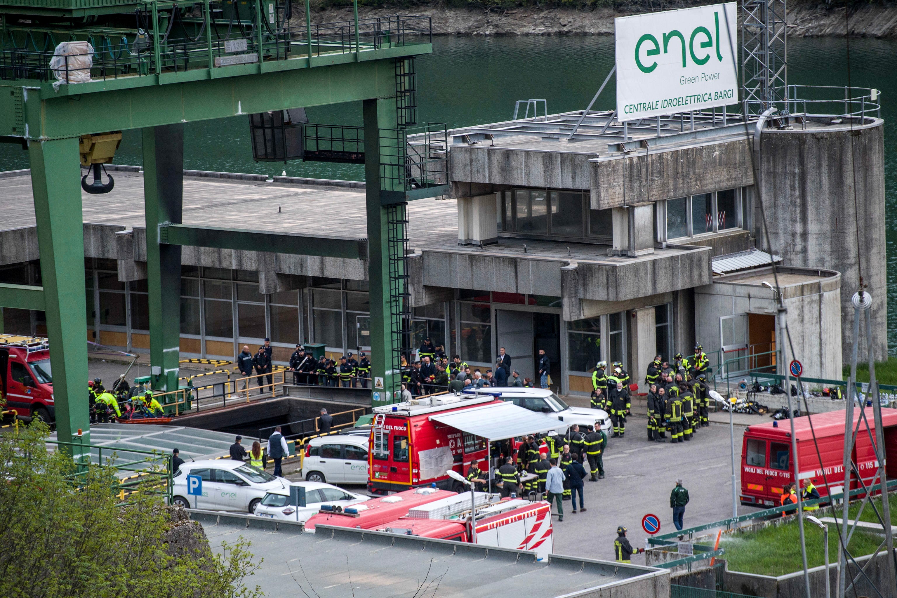 Rescuers work at the scene of an explosion that occurred in a hydroelectric power plant on the Lake Suviana reservoir