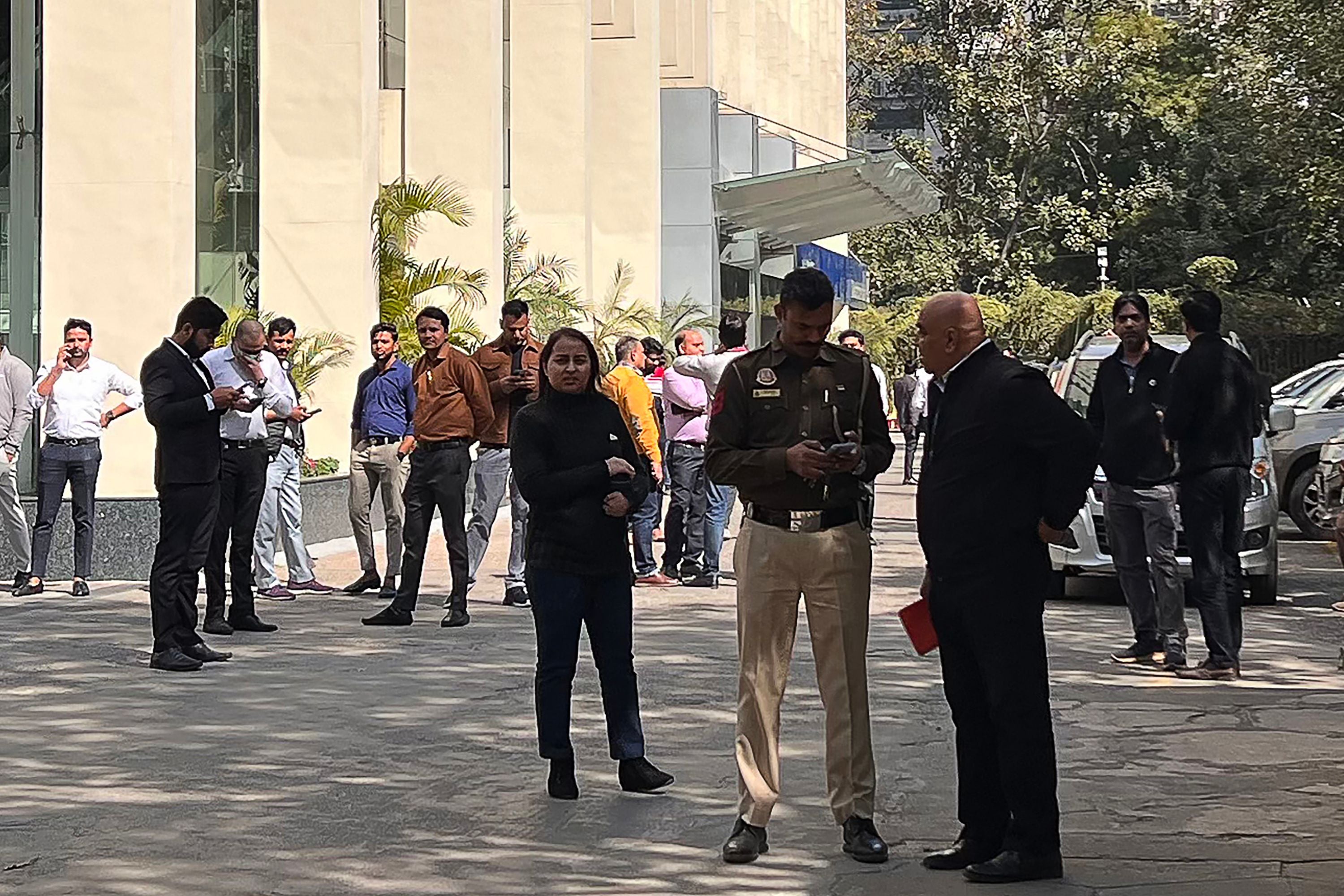 A police officer stands outside the BBC office in Delhi while Indian tax authorities conduct a raid