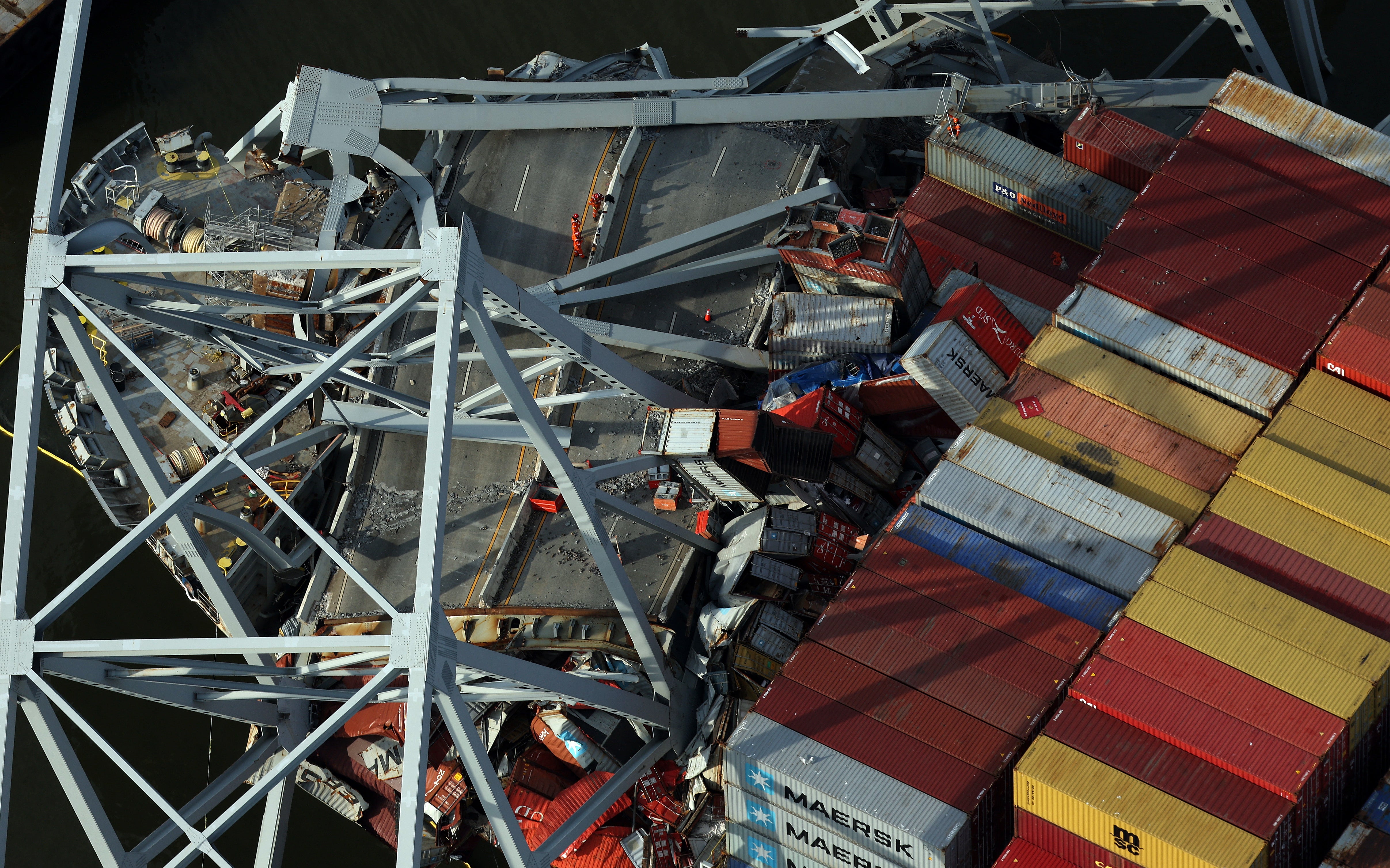 In an aerial view, salvage crews continue to remove wreckage from the cargo ship