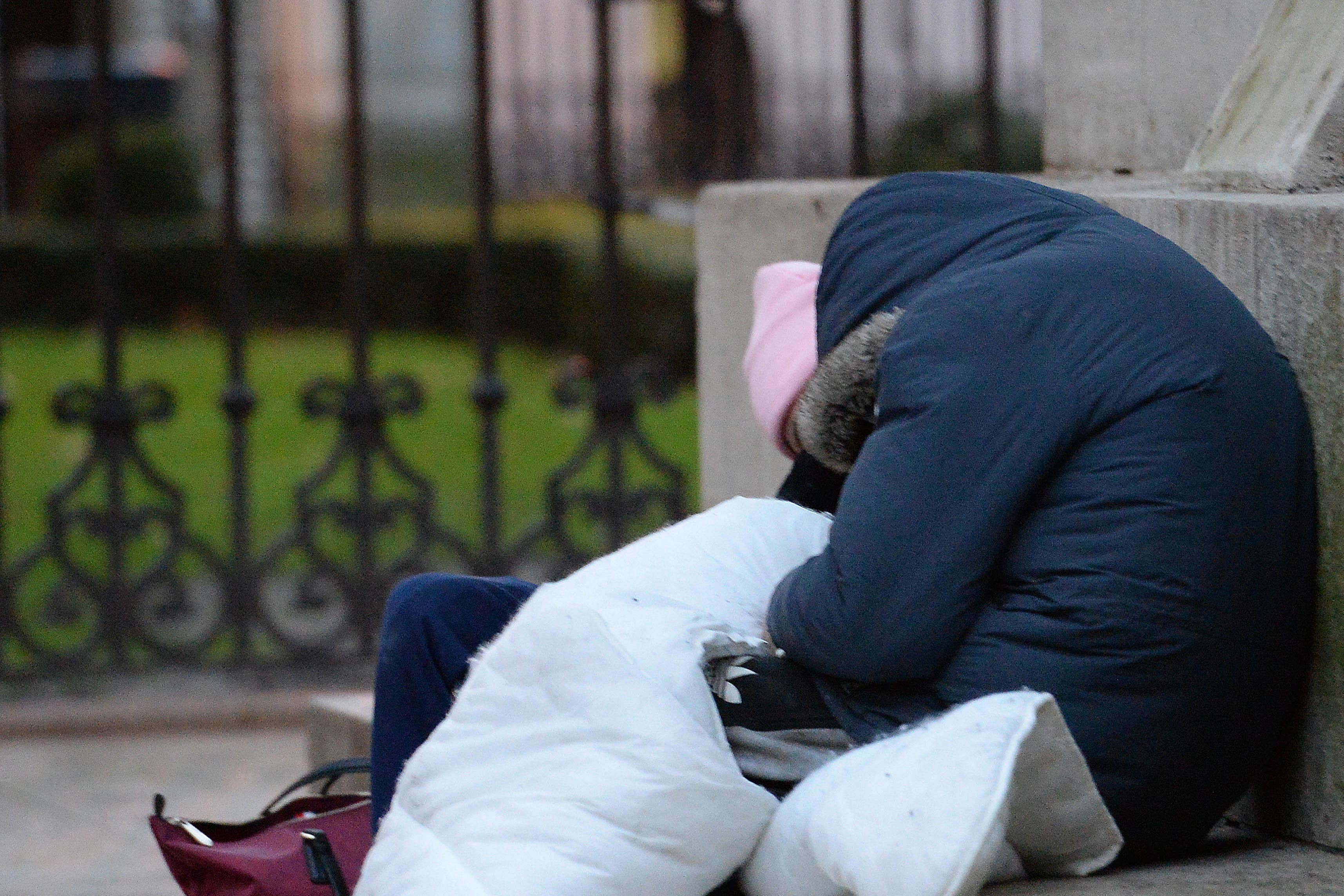 Homeless people sleep on the plinth of the Ferdinand Foch equestrian statue in Victoria, London (PA)