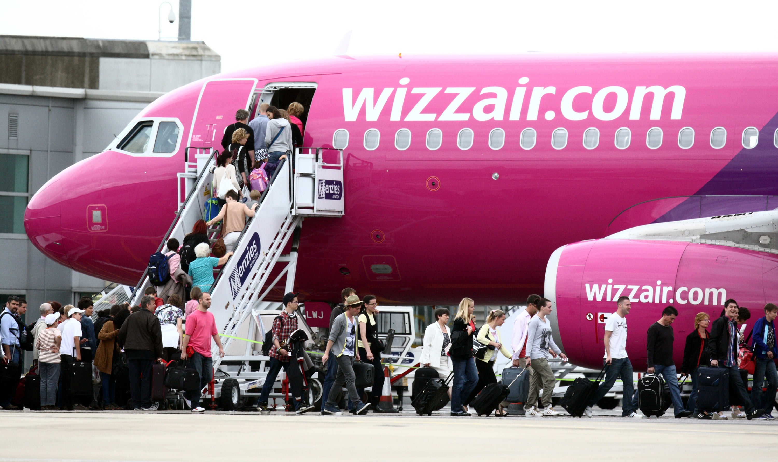 Passengers getting on a Wizz Air plane at Luton Airport