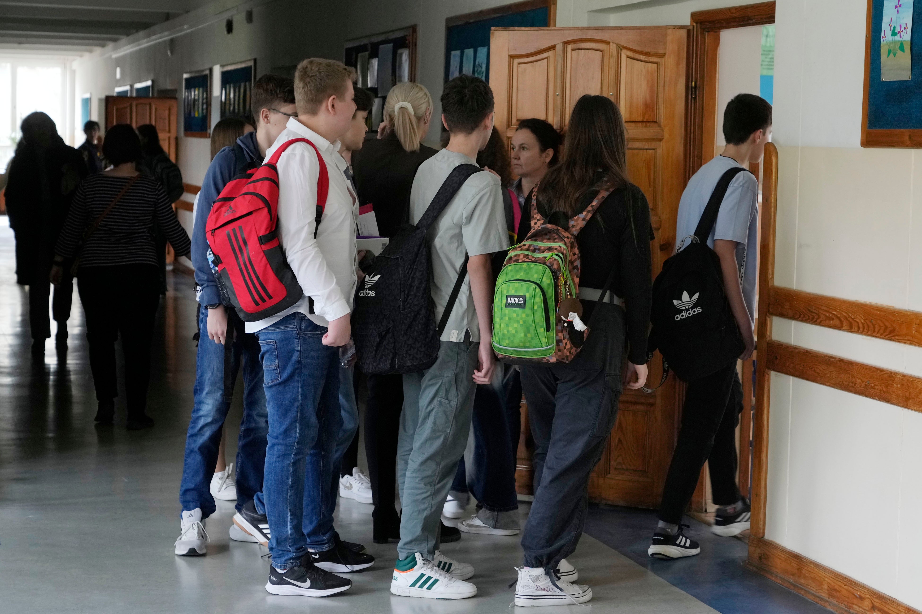 Children enter a classroom at the Primary School number 223 in Warsaw, Poland