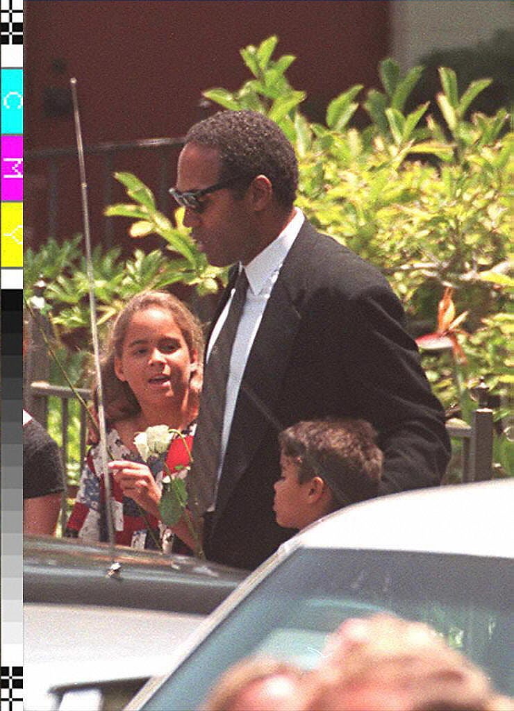 OJ Simpson- ex-football superstar O.J. Simpson accompanying his children, Sydney, 9 (L) and Justin, 6 (R), as they leave the funeral services for his ex-wife, Nicole Simpson, 16 June 1994