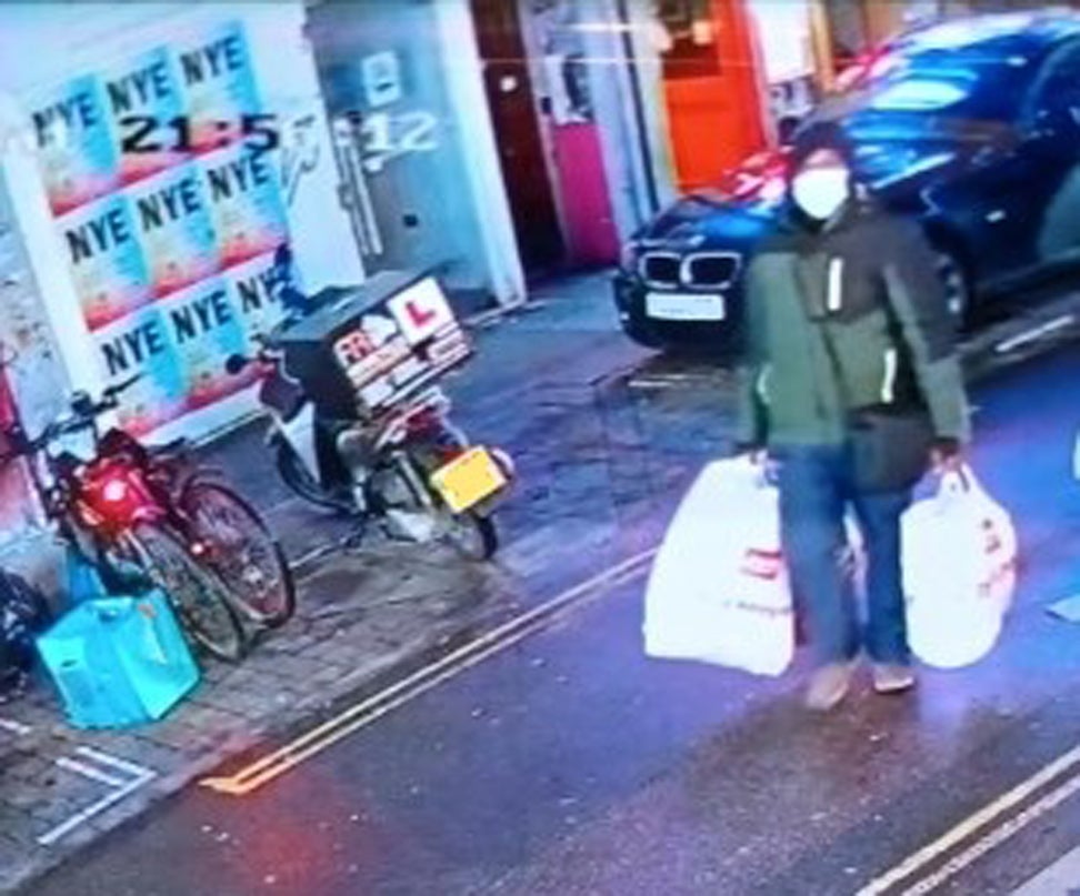 Gordon returning with Argos shopping bags on Brick Lane