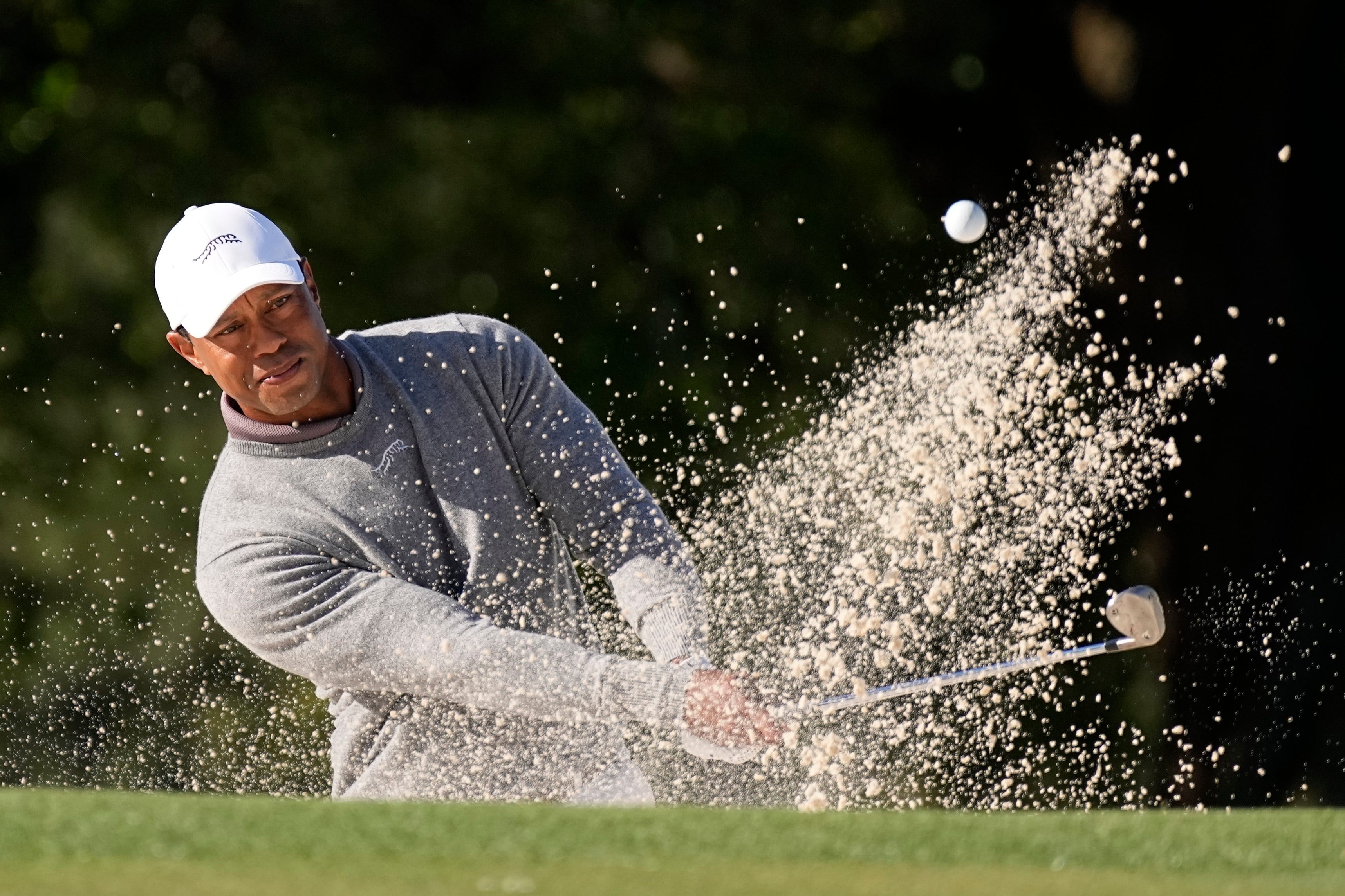 Tiger Woods hits from the bunker on the 18th hole during his first round of 73 in the 88th Masters (George Walker IV/AP)